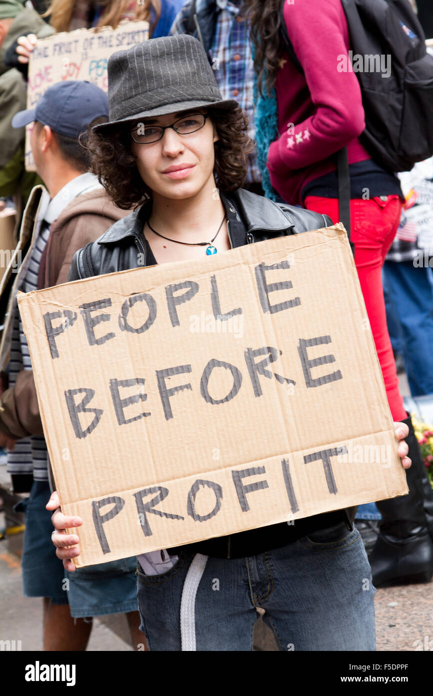 A protester at Occupy Wall Street holds a 'People before Profit' sign. Stock Photo