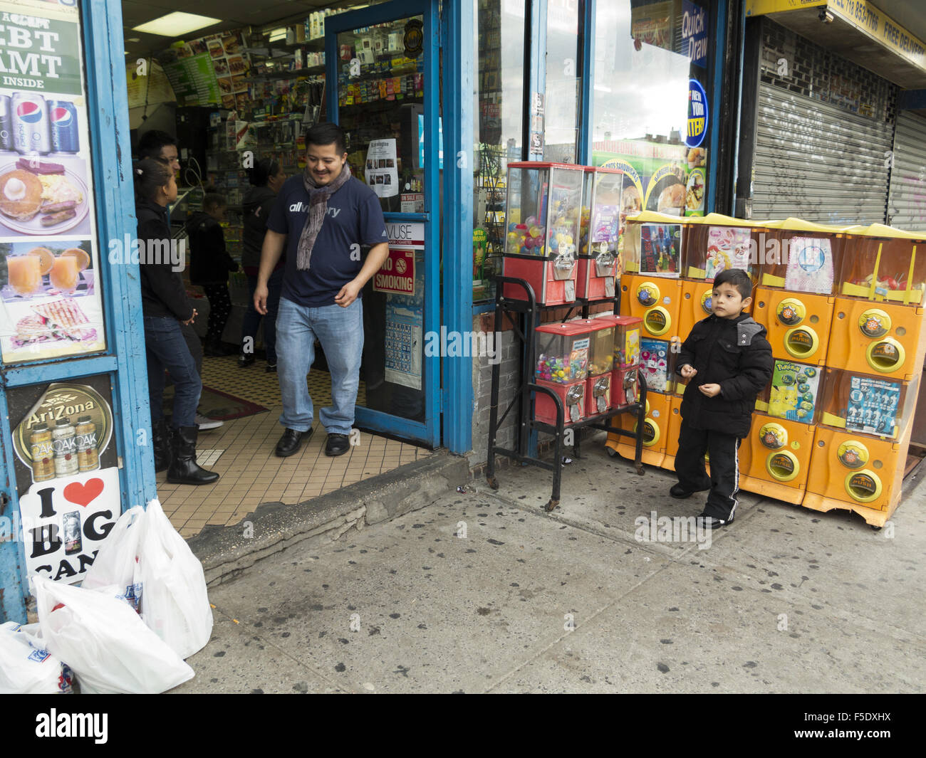 Mexicans in front of bodega in the Kensington section of Brooklyn, New York, 2015. Boy is wearing Day of the Dead face makeup. Stock Photo