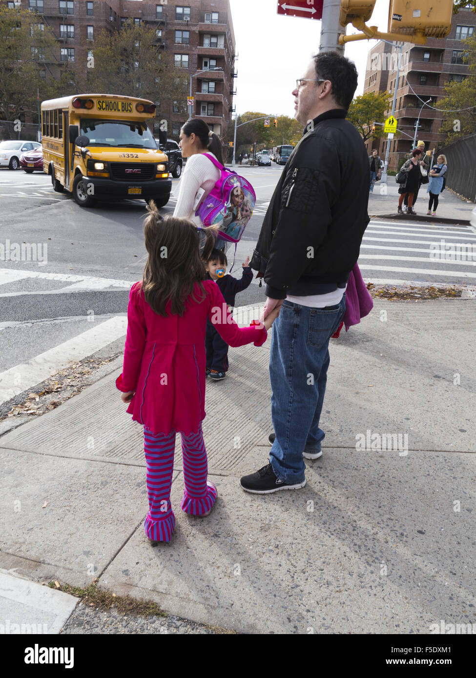 Children going home with parents after school in Kensington, Brooklyn, NY, 2015. Stock Photo