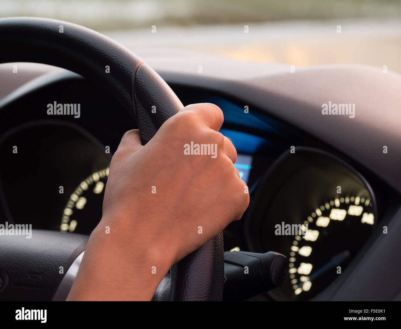 One hand driving car showing meters Stock Photo - Alamy