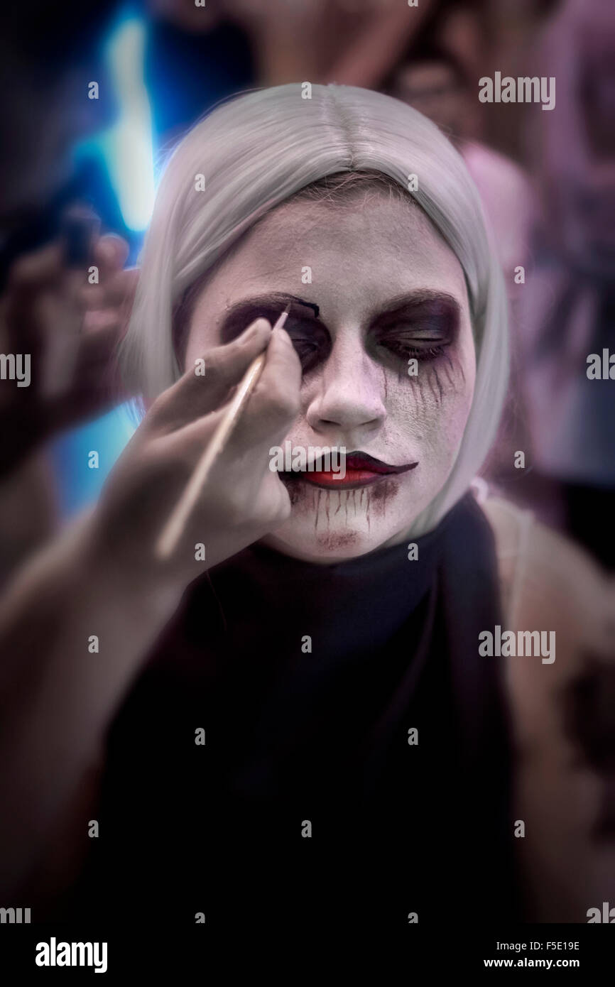 Halloween Zombie face mask up. Female undergoing makeup Stock Photo Alamy