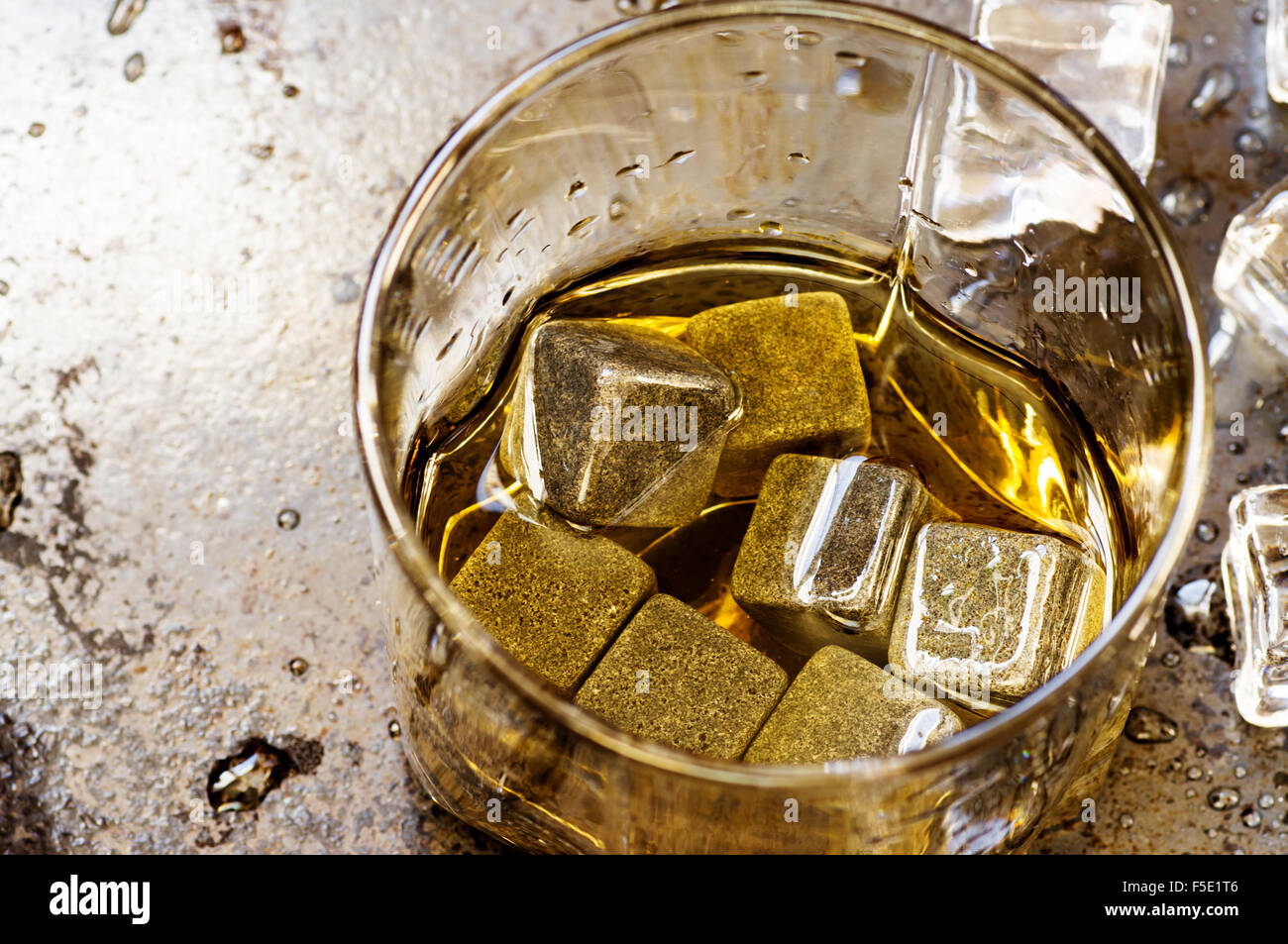 Whisky stones in glass and ice on black background Stock Photo