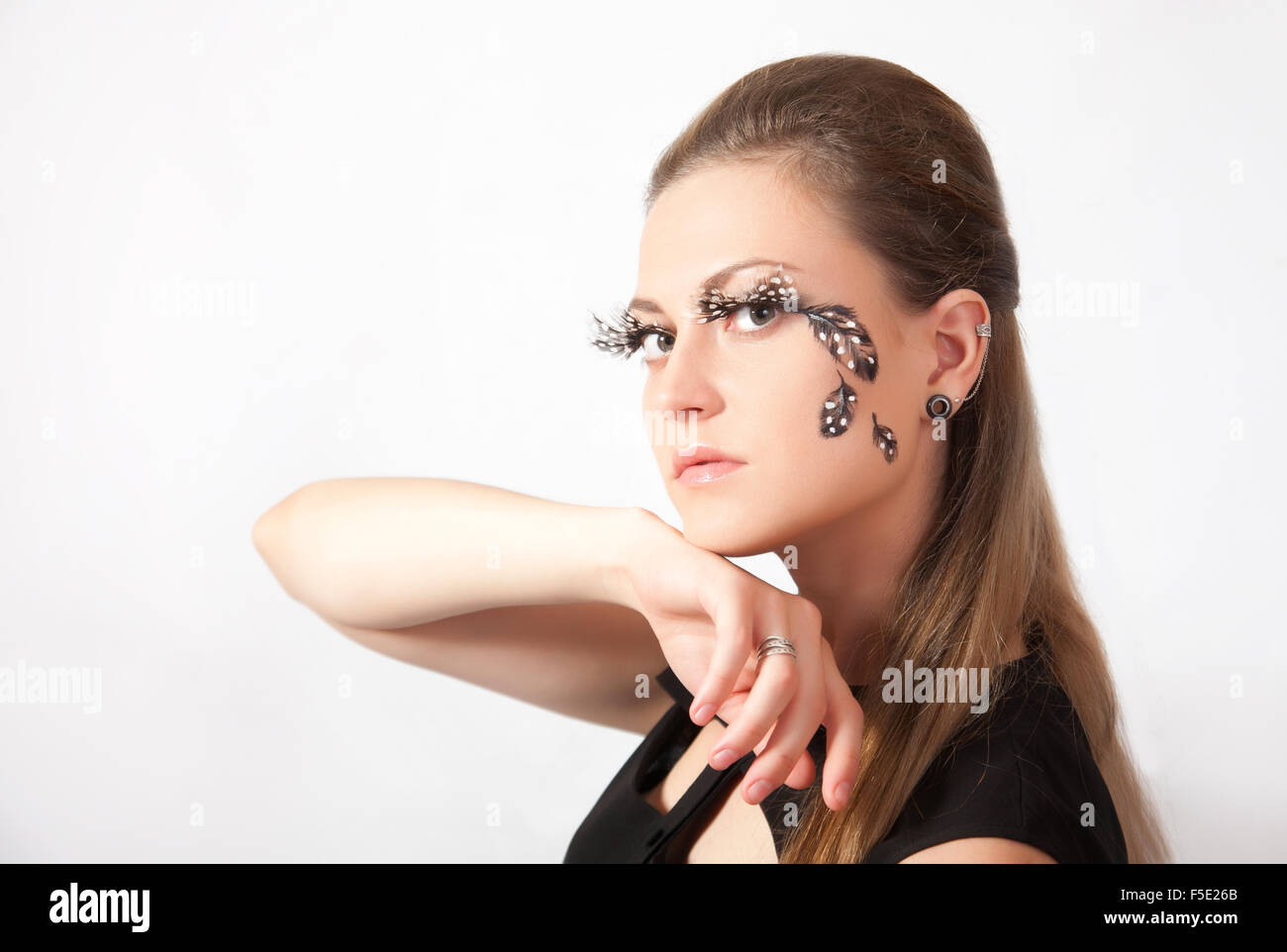 Beautiful woman with big eyelashes and face-art Stock Photo