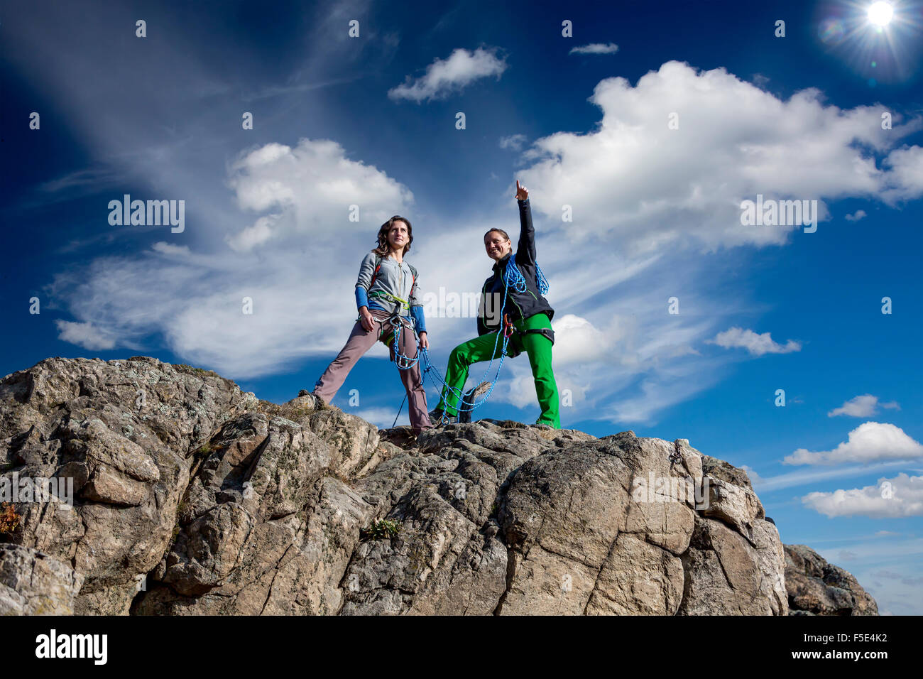 Group of two female climbers observing the surroundings from the summit