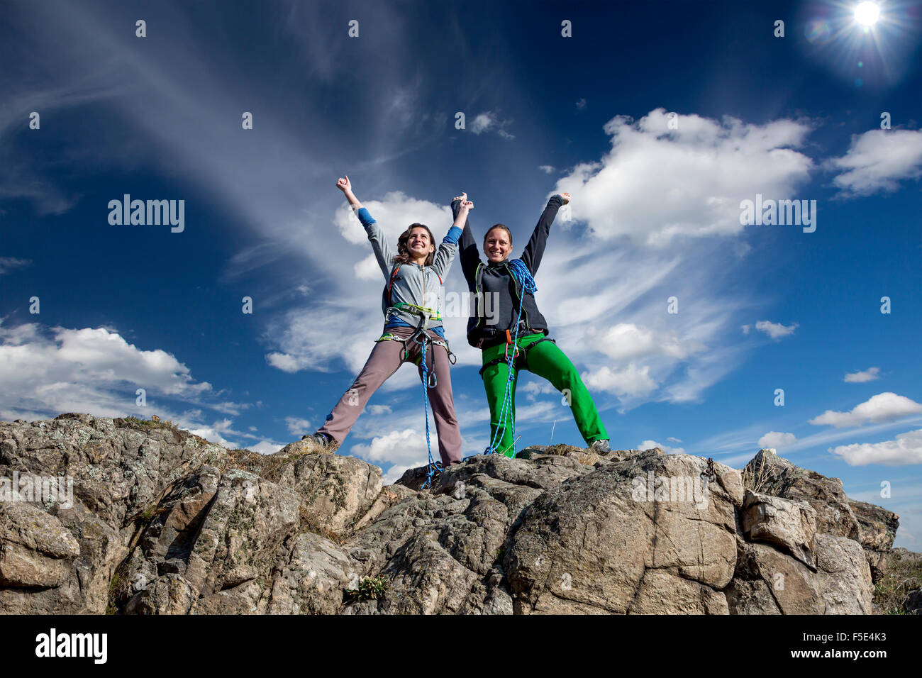 Group of two happy female climbers that are just conquered the summit