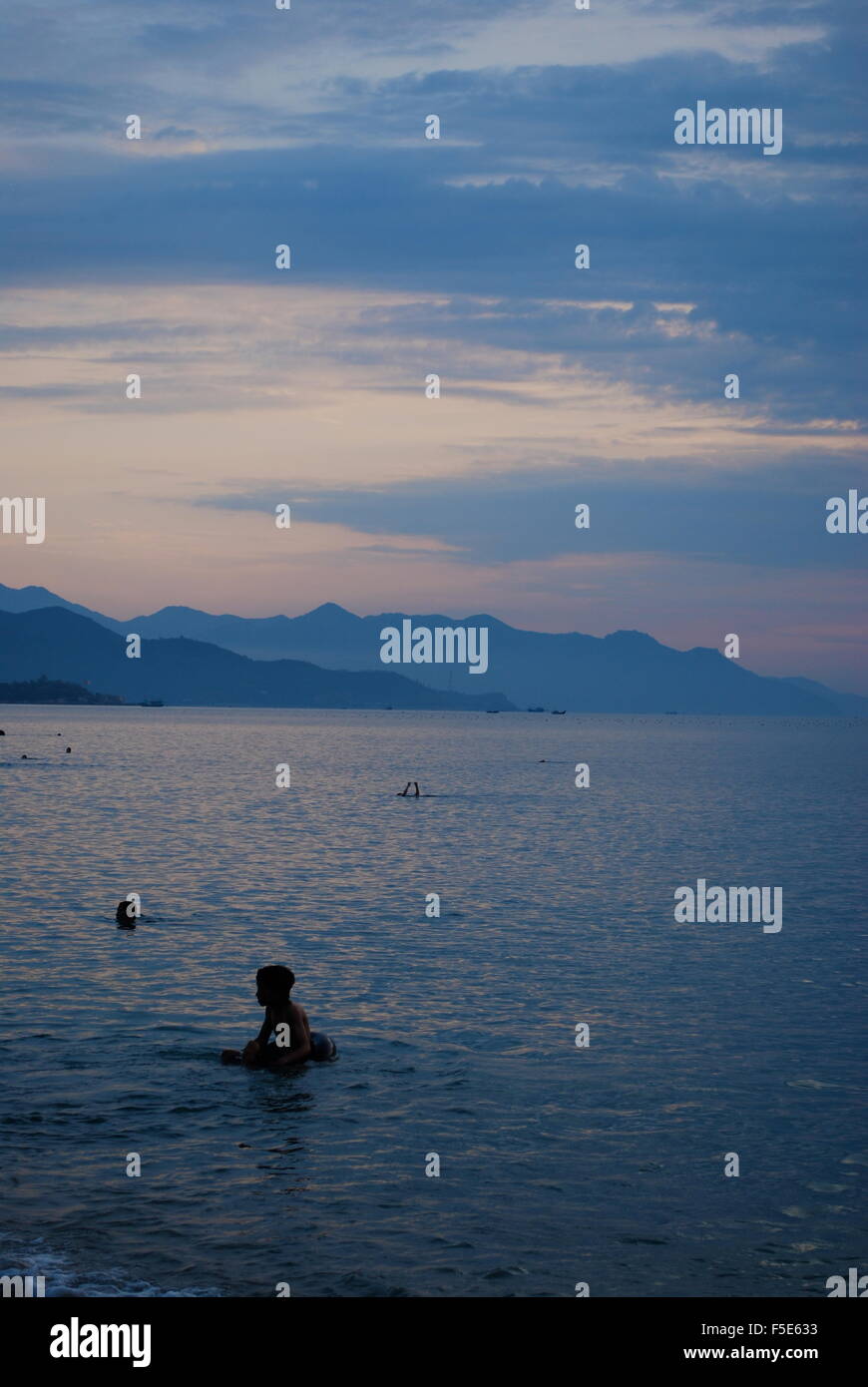 View of locals on the city beach in Nha Trang, Vietnam. Stock Photo