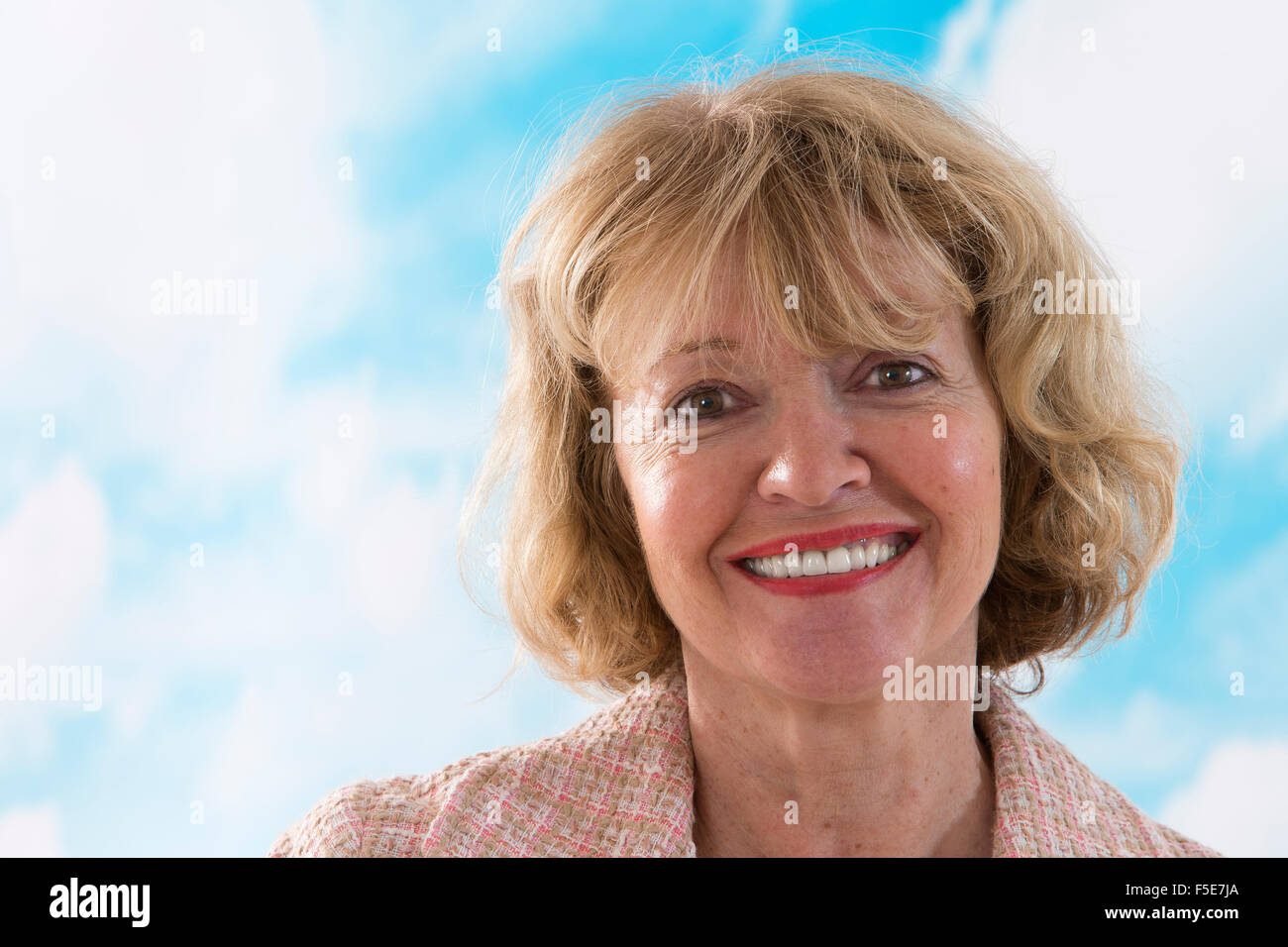 Portrait of smiling businesswoman standing in office Stock Photo - Alamy