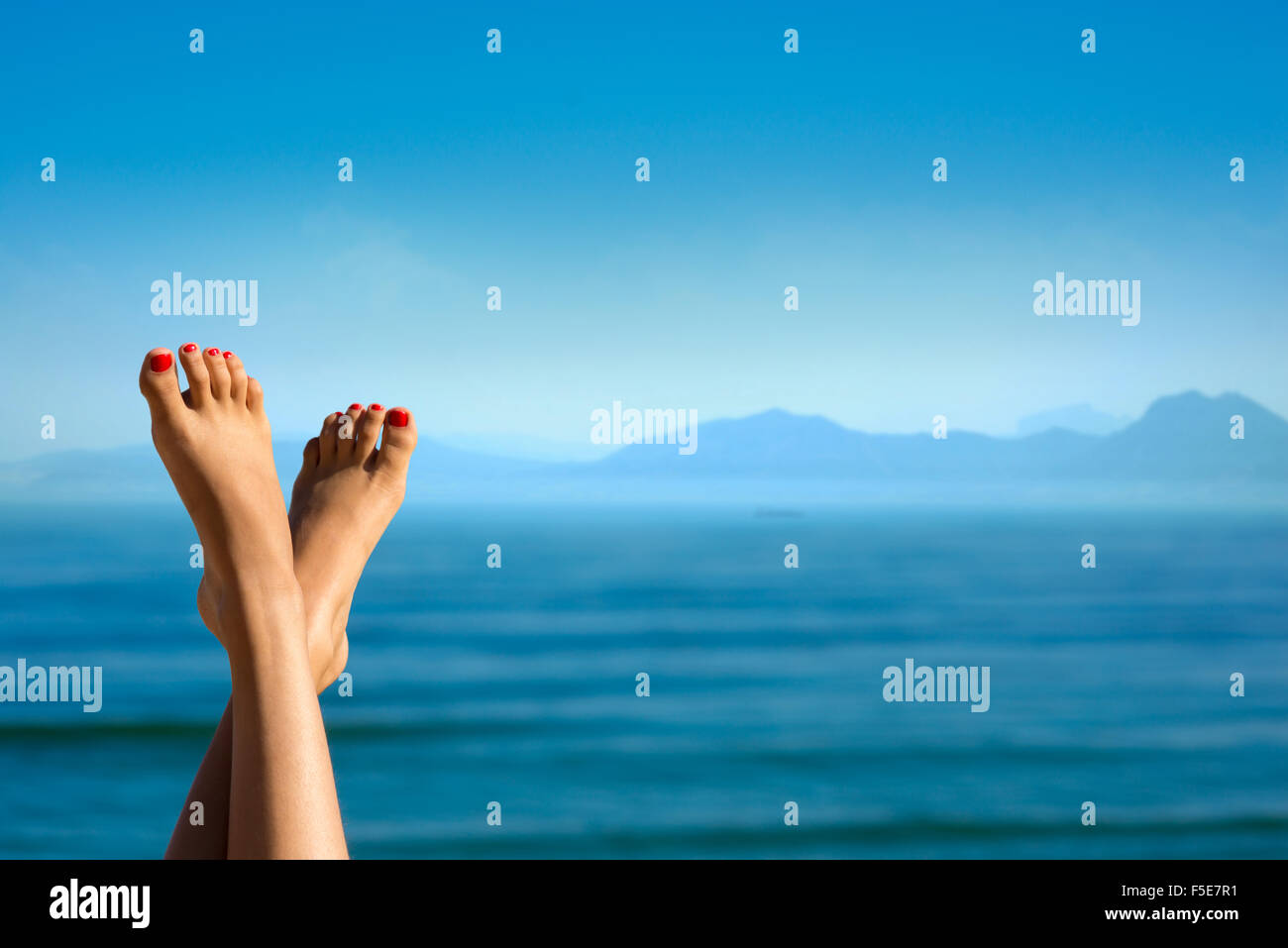 Girl's feet on the background of mountains. Stock Photo