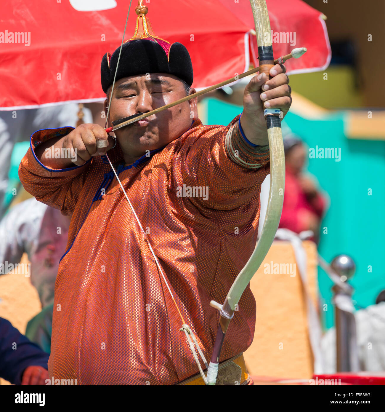 Male archer takes aim, National Archery Tournament, Archery Field, Naadam Festival, Ulaan Baatar (Ulan Bator), Mongolia, Asia Stock Photo