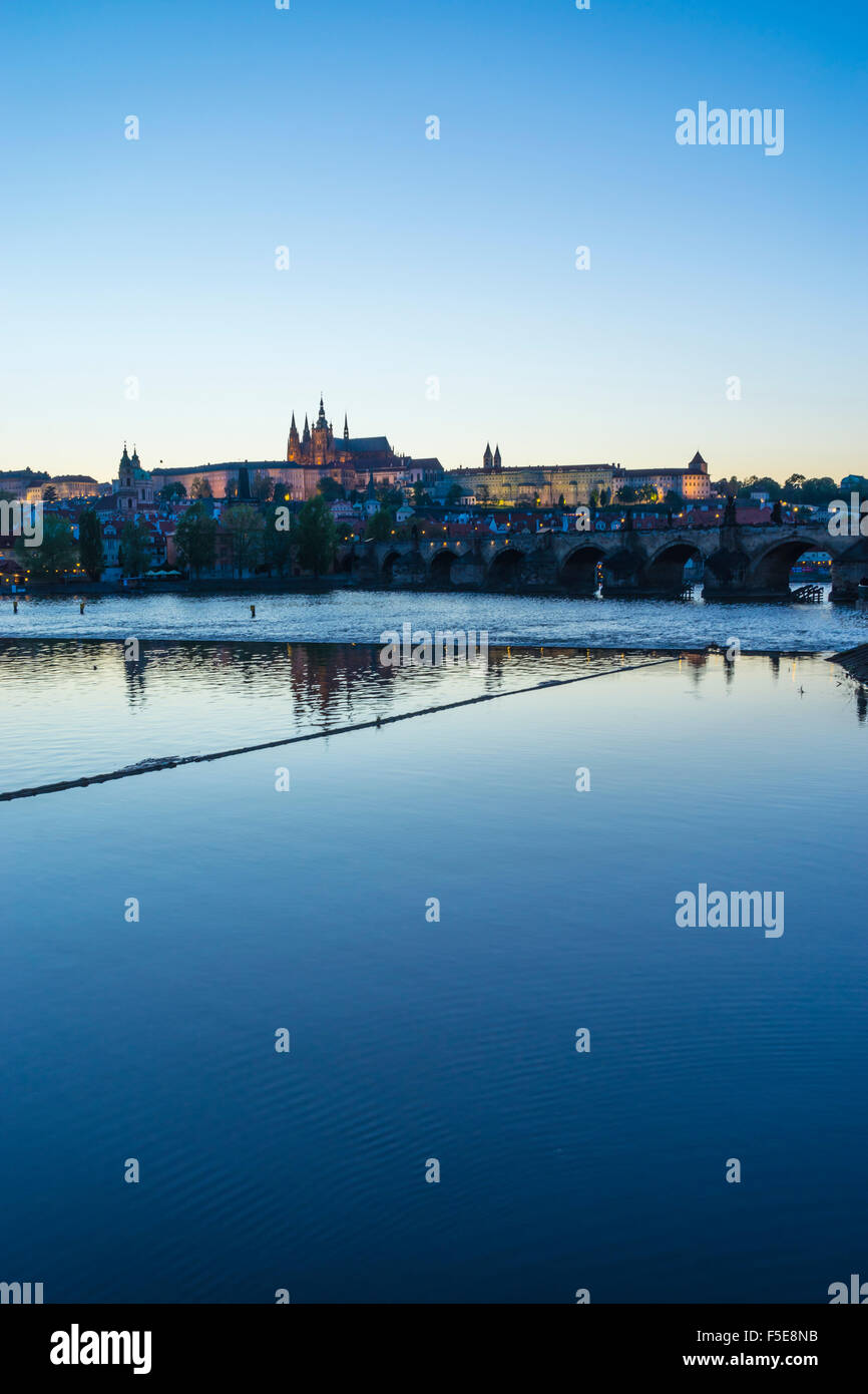 View of Charles Bridge, the Castle District and St. Vitus's Cathedral across the Vltava River at sunset, Prague, Czech Republic Stock Photo