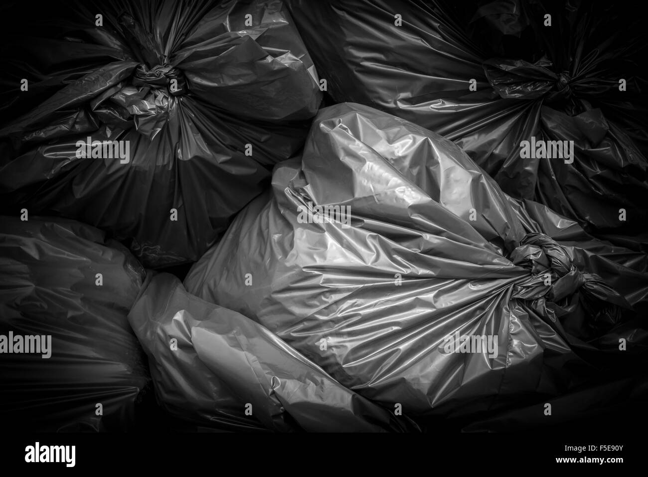 Garbage bags black stacked and ready to be picked Stock Photo Alamy