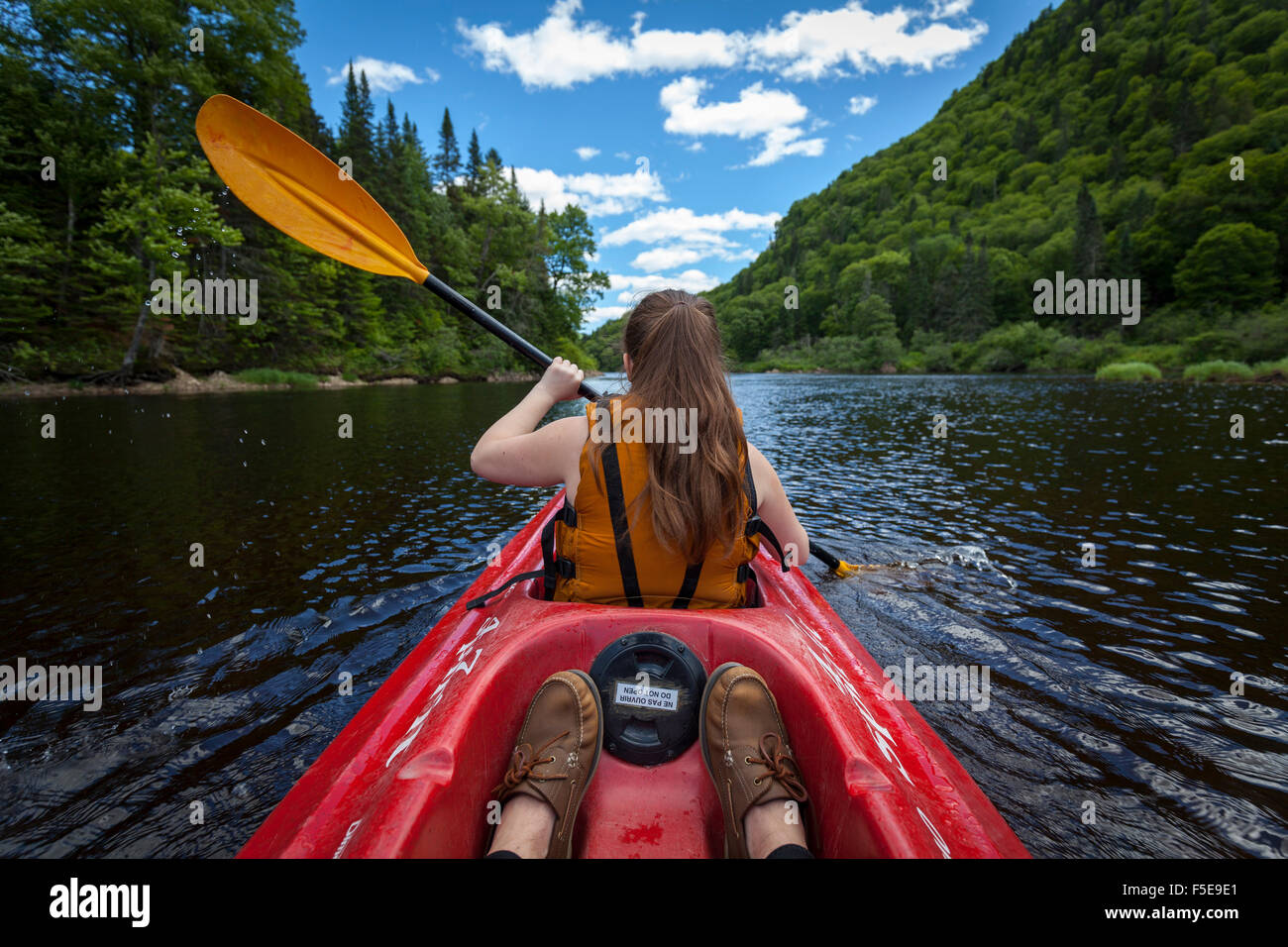 Young woman paddles down river in a kayak, Jacques-Cartier National Park, Quebec, Canada, North America Stock Photo