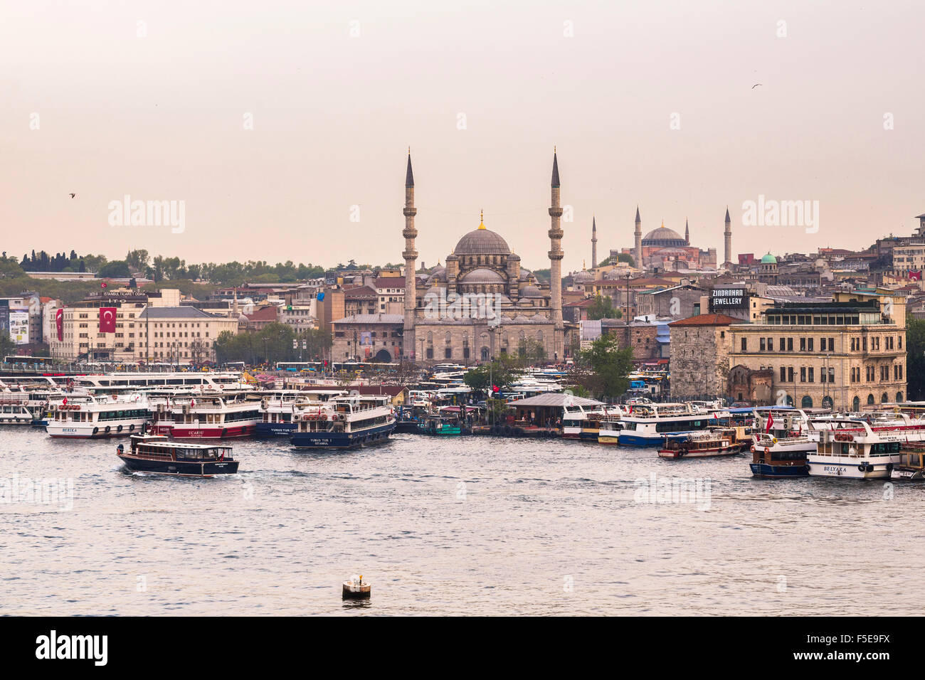 New Mosque (Yeni Cami) with Hagia Sophia (Aya Sofya) behind seen across the Golden Horn, Istanbul, Turkey, Europe Stock Photo