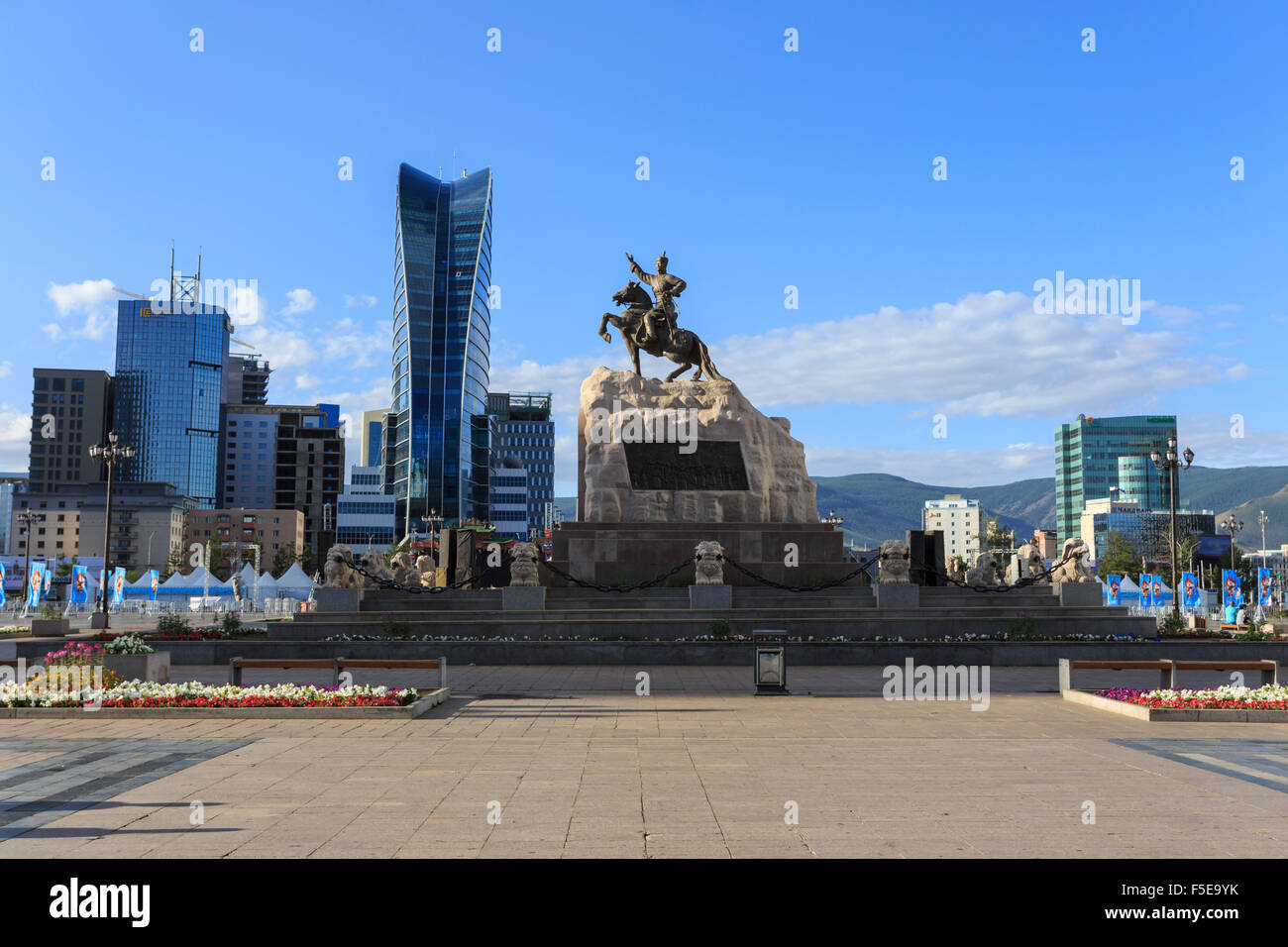 Statue of Sukhbaatar on horse, with new development behind, blue sky, Chinggis Khaan Square, Ulaanbaatar (Ulan Bator), Mongolia Stock Photo