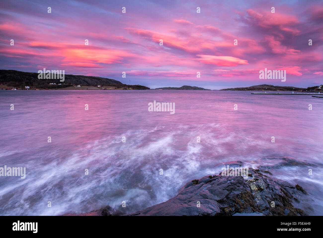 Pink sky at sunrise reflected in the cold waters, Flatanger, Trondelag, Norway, Scandinavia, Europe Stock Photo