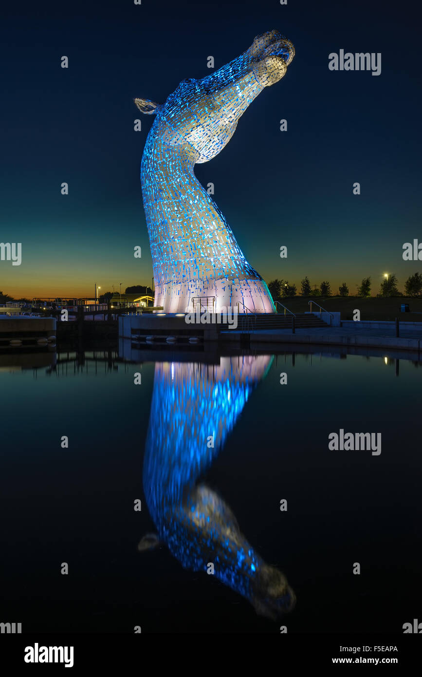 The Kelpies Horse statue lit up at night at The Helix Park in Falkirk, Scotland Stock Photo