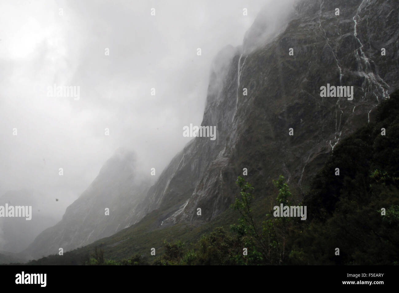 Mountains and rain near Milford sound, Fiordland National Park, South Island, New Zealand Stock Photo
