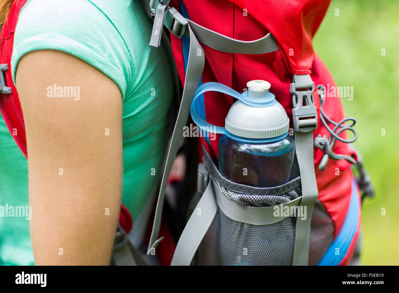 close up of woman with water bottle in backpack Stock Photo - Alamy