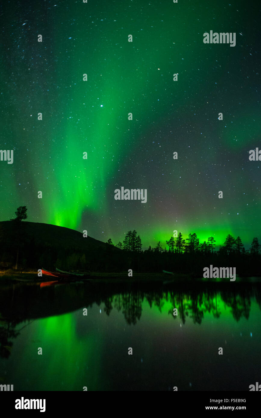 Aurora Borealis and stars over lake at night, Muonio, Lapland, Finland, Scandinavia, Europe Stock Photo
