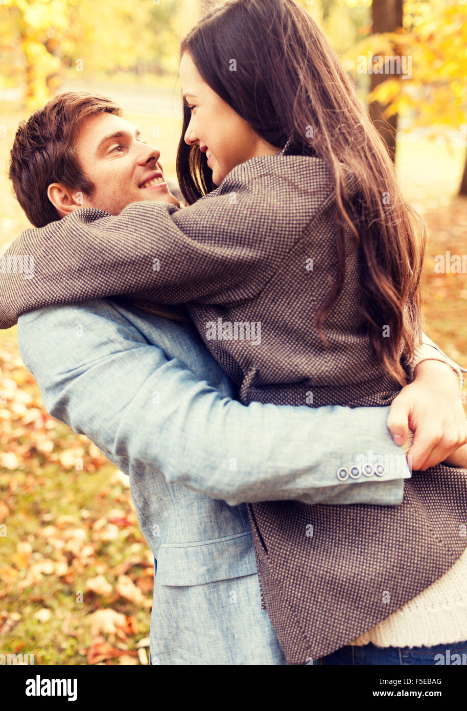 smiling couple hugging in autumn park Stock Photo - Alamy