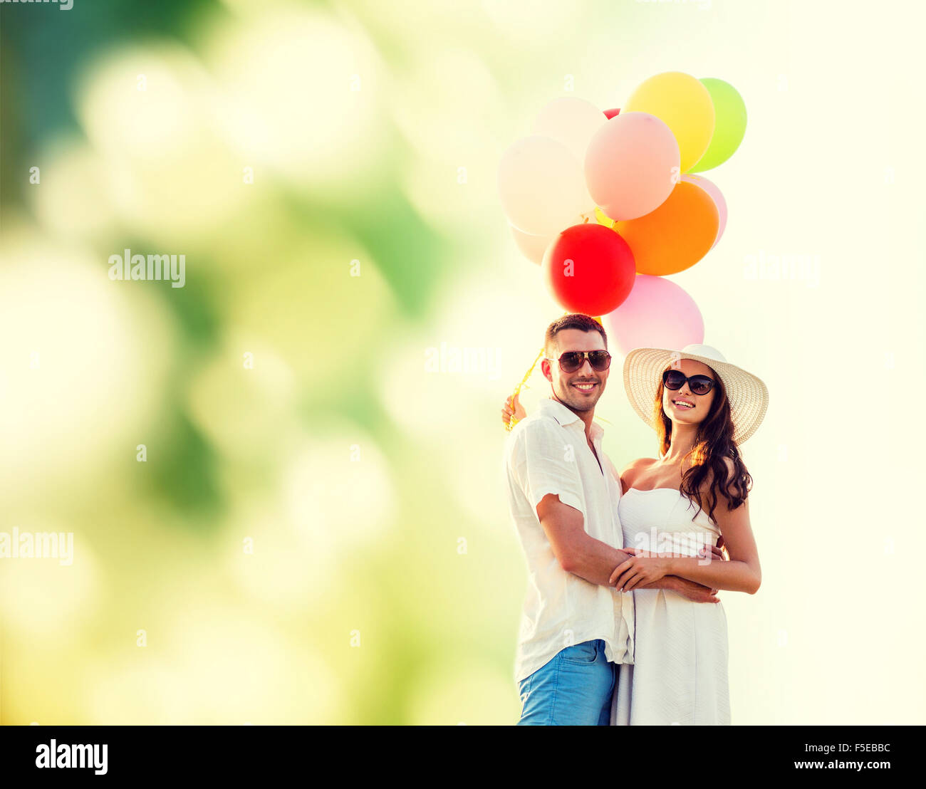 smiling couple with air balloons outdoors Stock Photo - Alamy