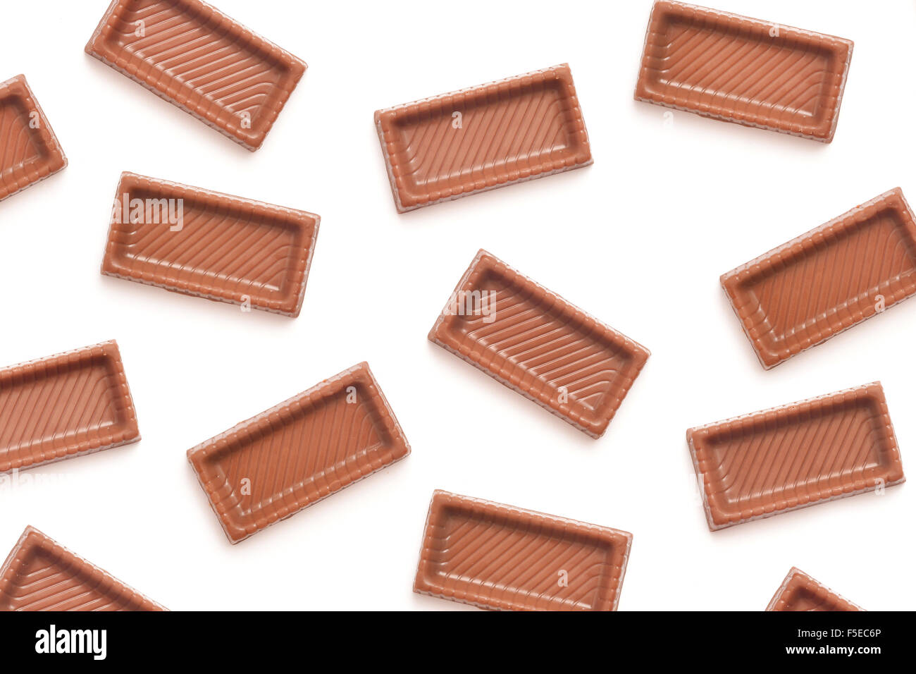 chocolate candy pieces background on white Stock Photo Alamy