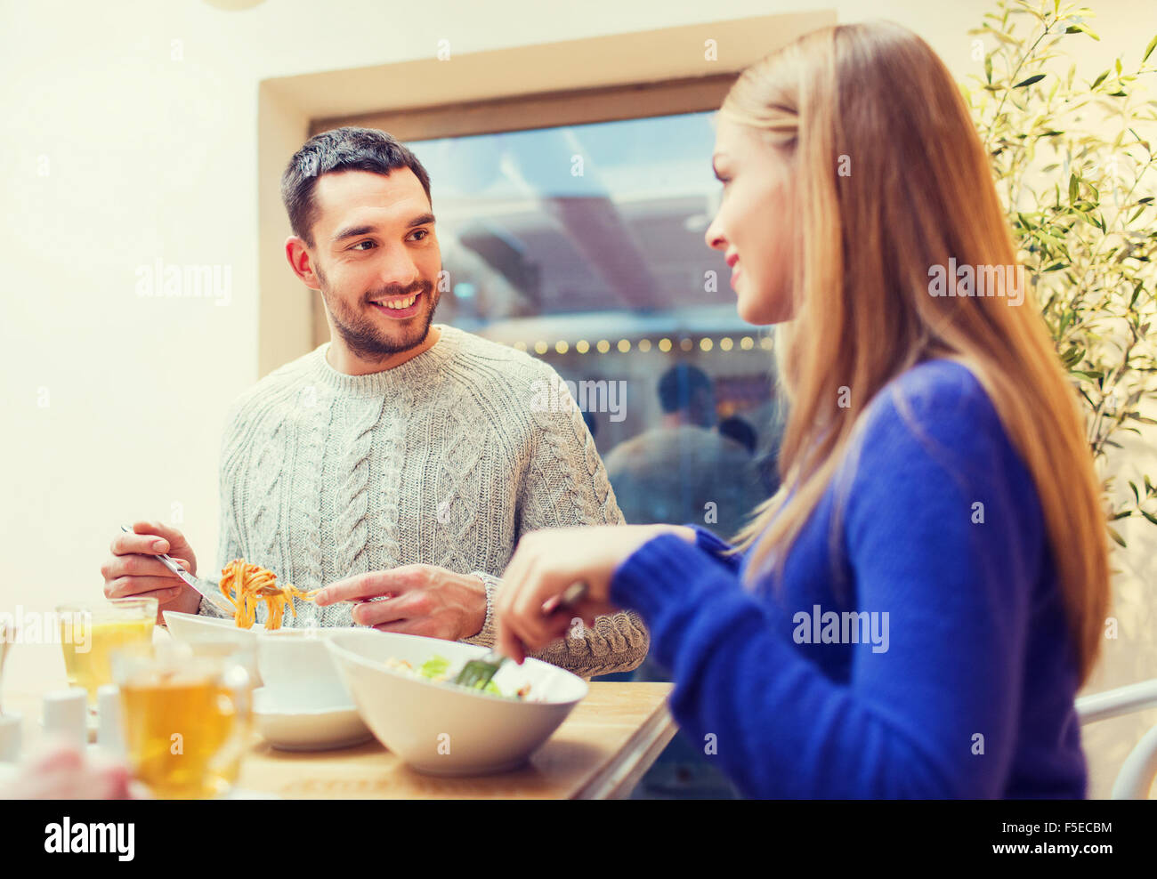 happy couple meeting and having dinner at cafe Stock Photo