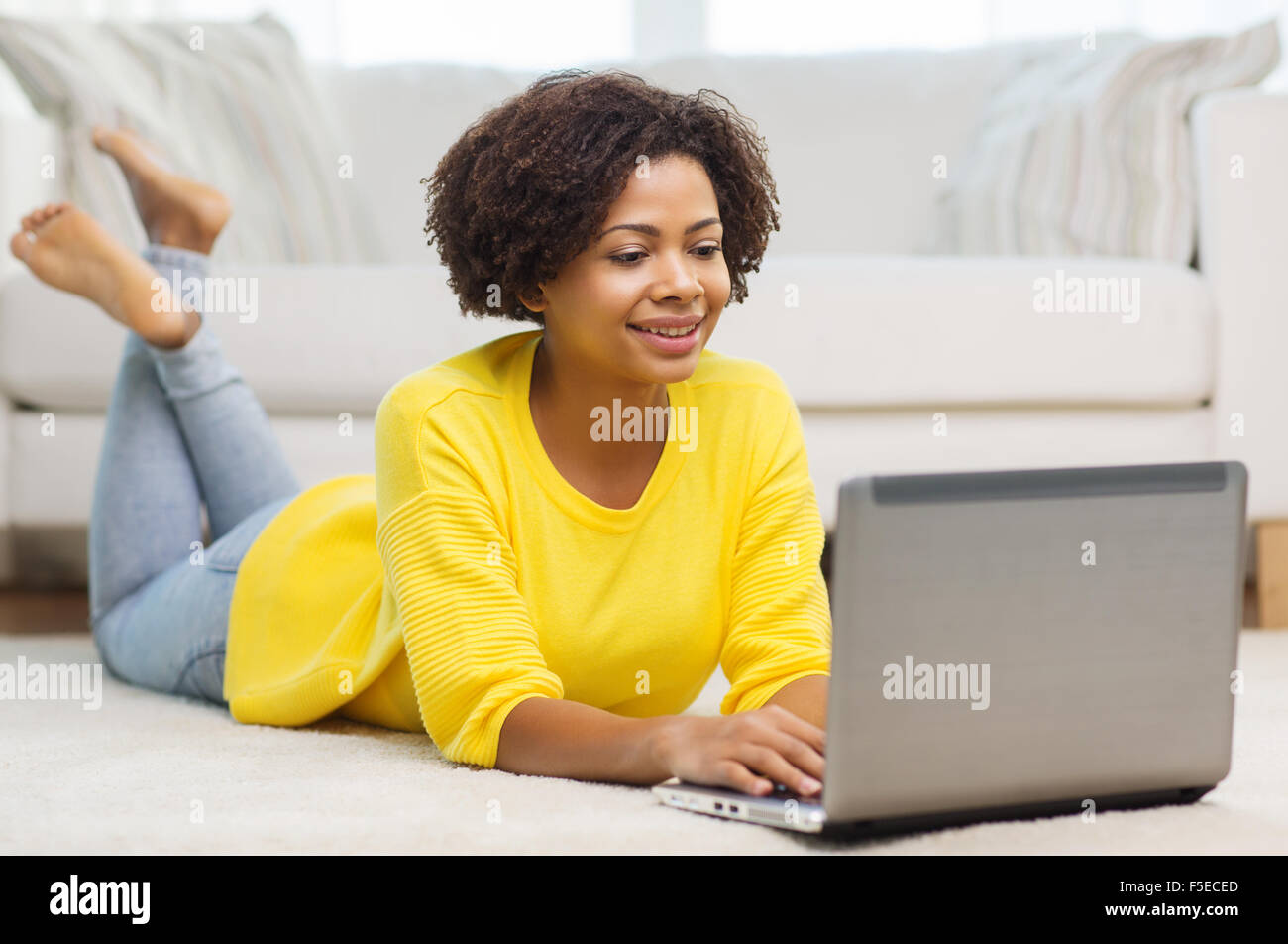 happy african american woman with laptop at home Stock Photo - Alamy