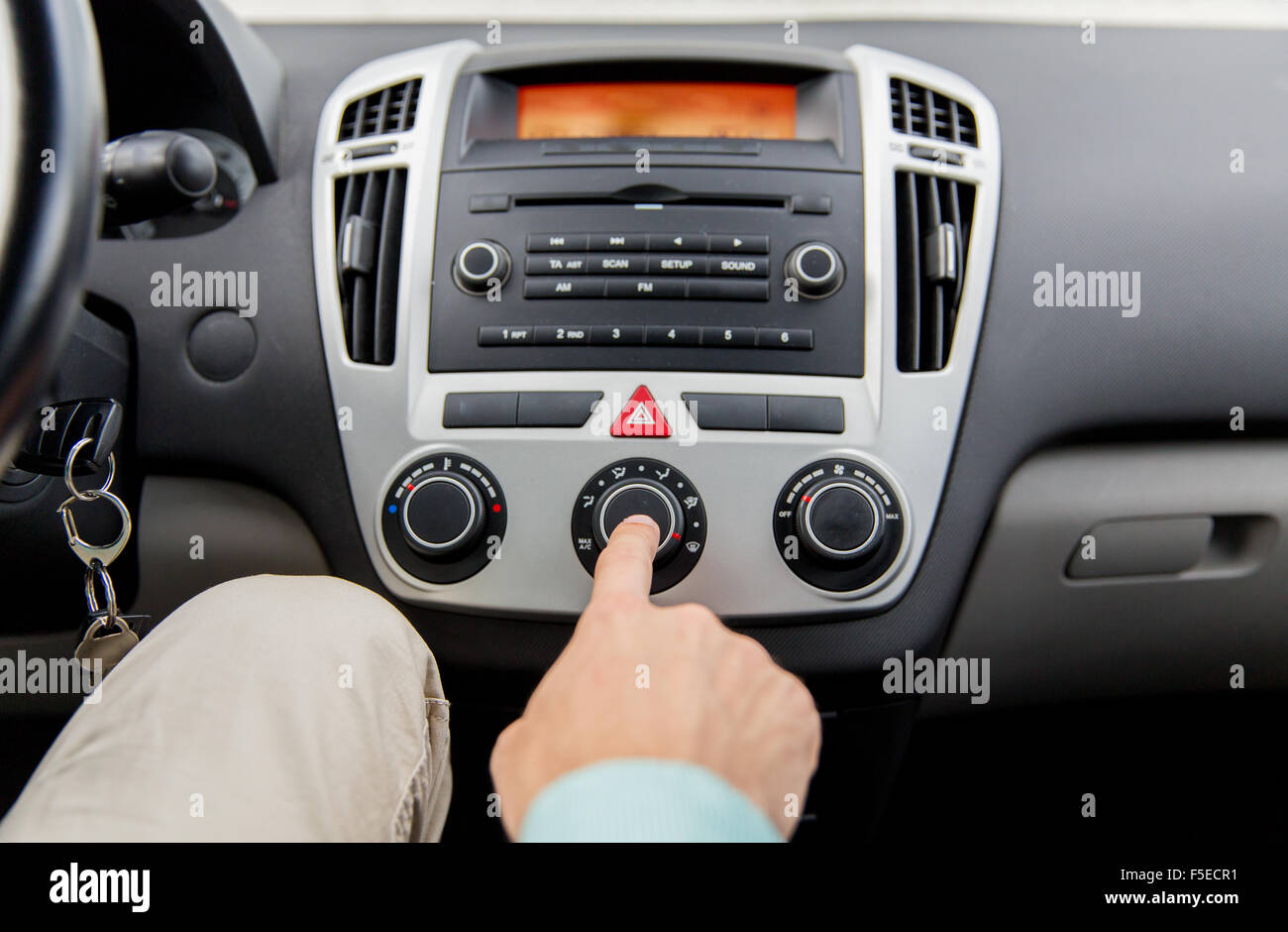 close up of male hand using climate control in car Stock Photo