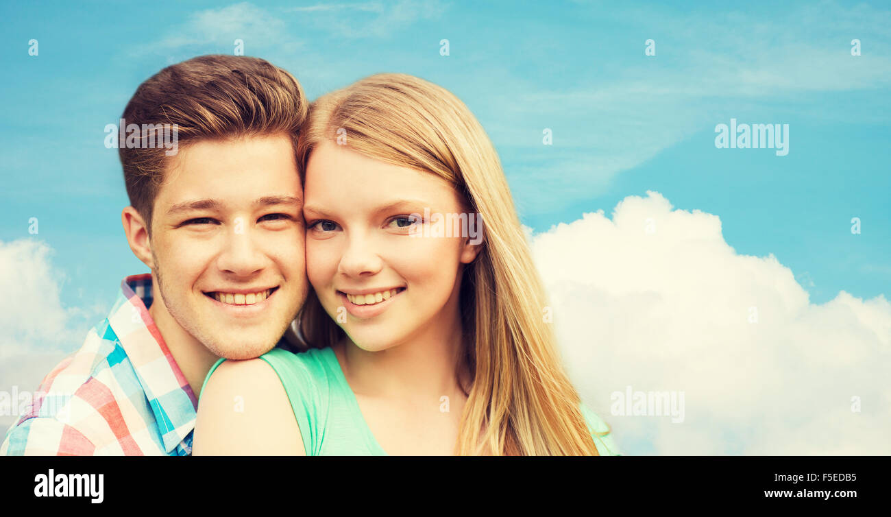 smiling couple hugging over blue sky background Stock Photo - Alamy