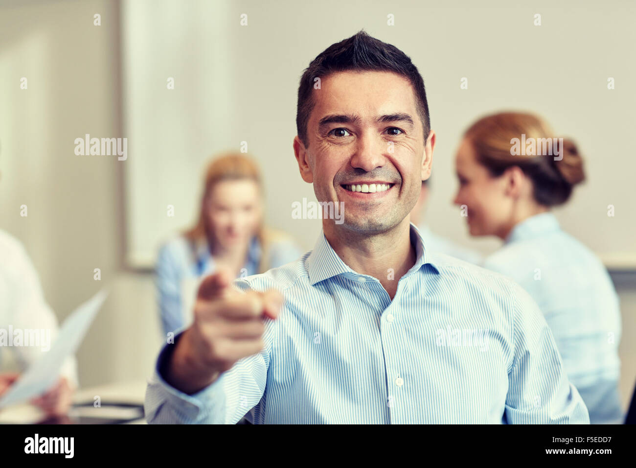 group of smiling businesspeople meeting in office Stock Photo - Alamy