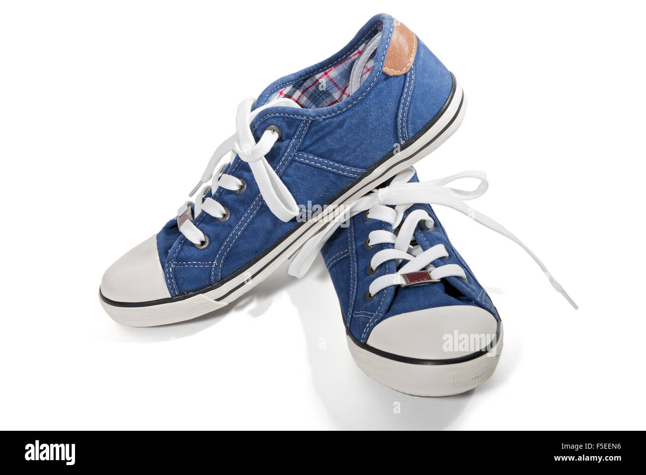 Pair of blue canvas sneakers isolated on white background Stock Photo ...