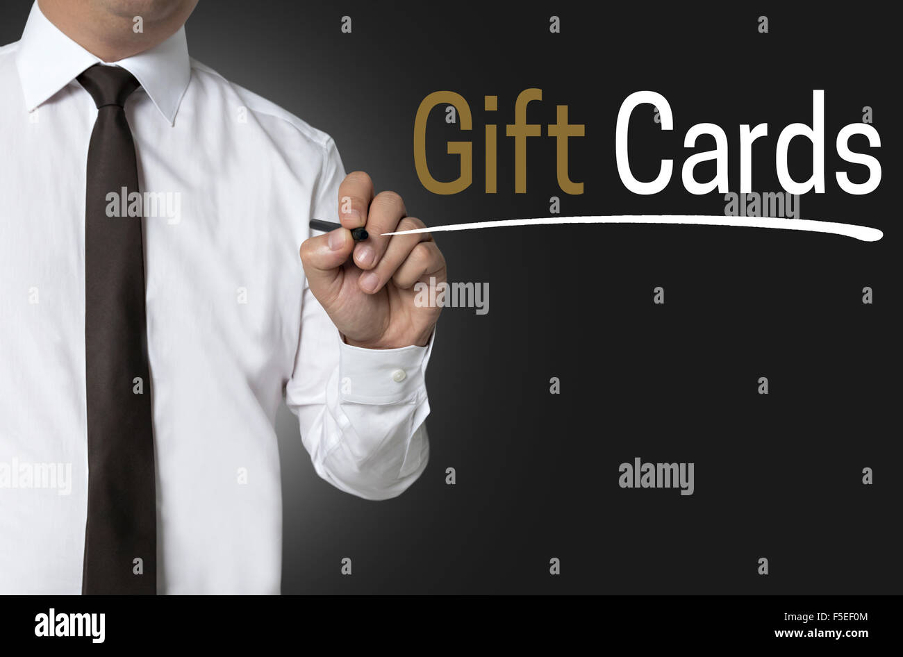 Gift cards is written by businessman background concept. Stock Photo