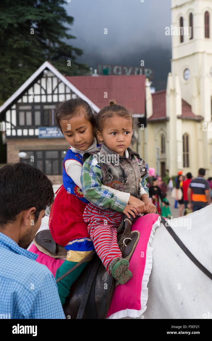 India, Himachal Pradesh, Shimla (Simla), Ridge, Scandal Point, children riding horse outside Christ Church Stock Photo