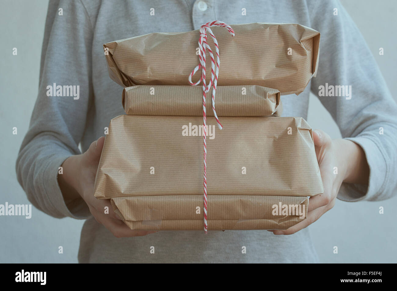 Boy holding a stack of presents Stock Photo
