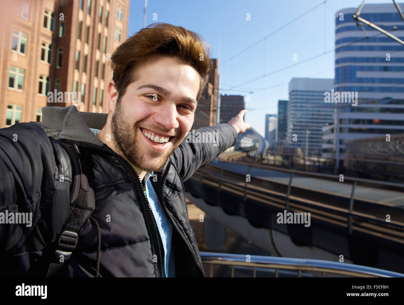 Close up portrait of a young man taking selfie in the city Stock Photo