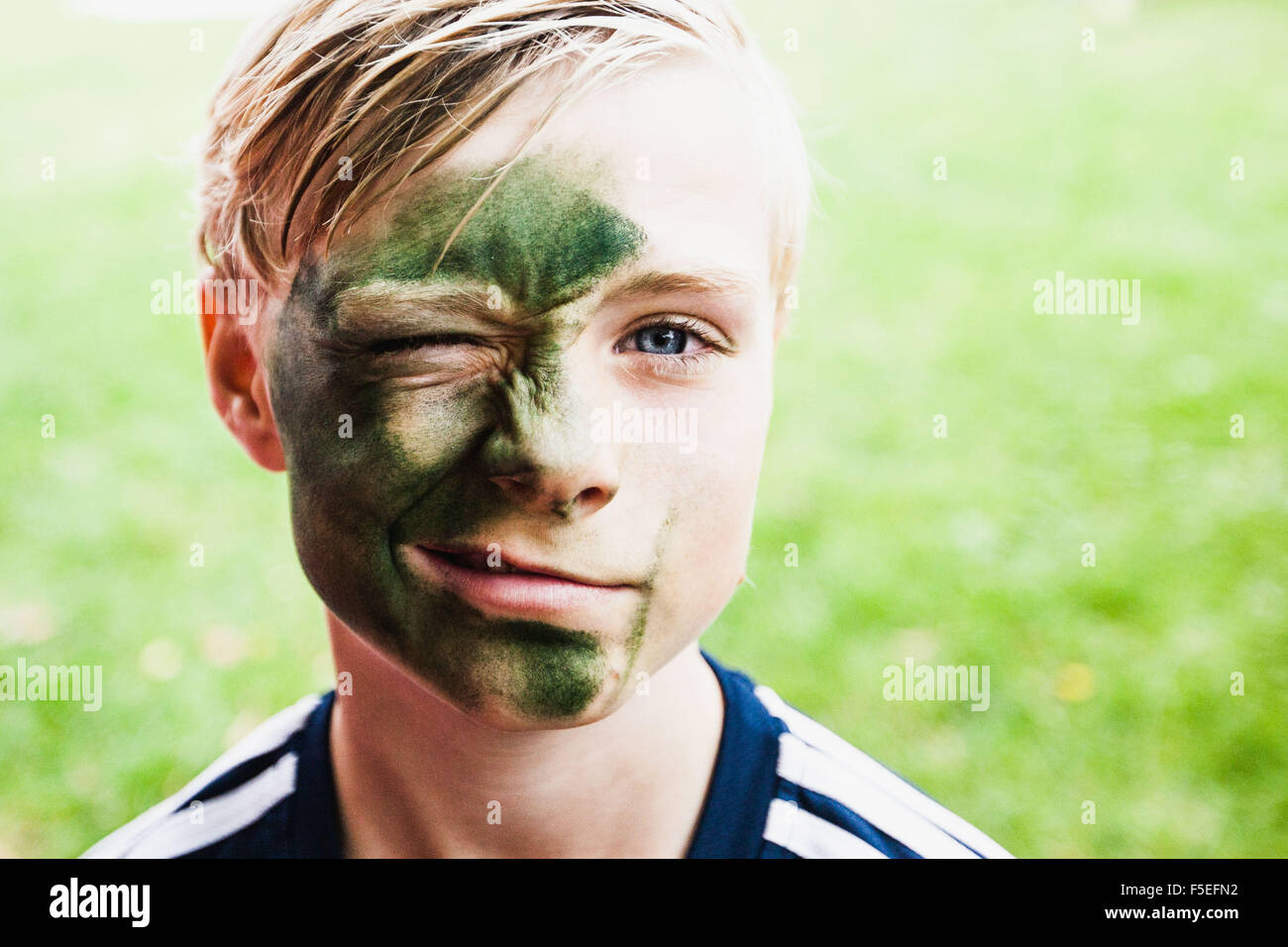 Portrait of a young boy with paint on his face hires stock photography