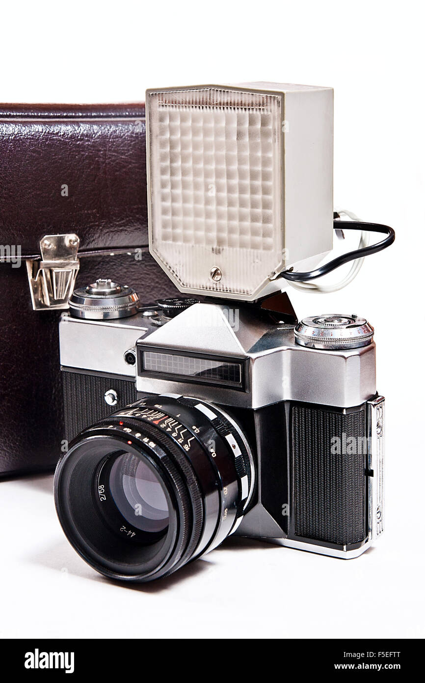 Old range finder vintage camera with flash isolated on white. Old camera flash with a leather case isolated on a white backgroun Stock Photo