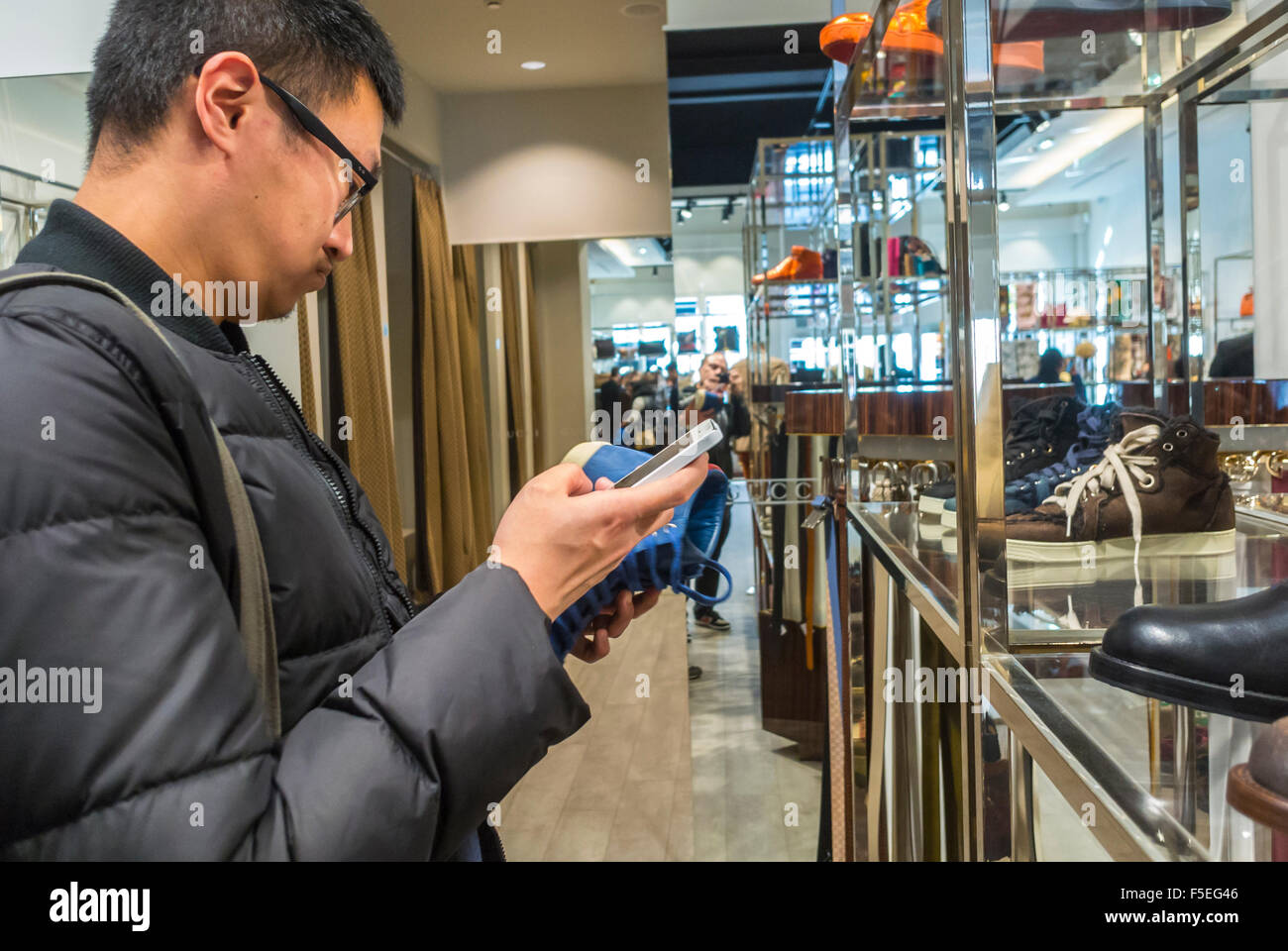 Paris, France, Chinese Tourist Taking pictures with Iphone while Shopping  in Luxury Stores in "La Vallee Village", Discount Shops, Gucci Stock Photo  - Alamy
