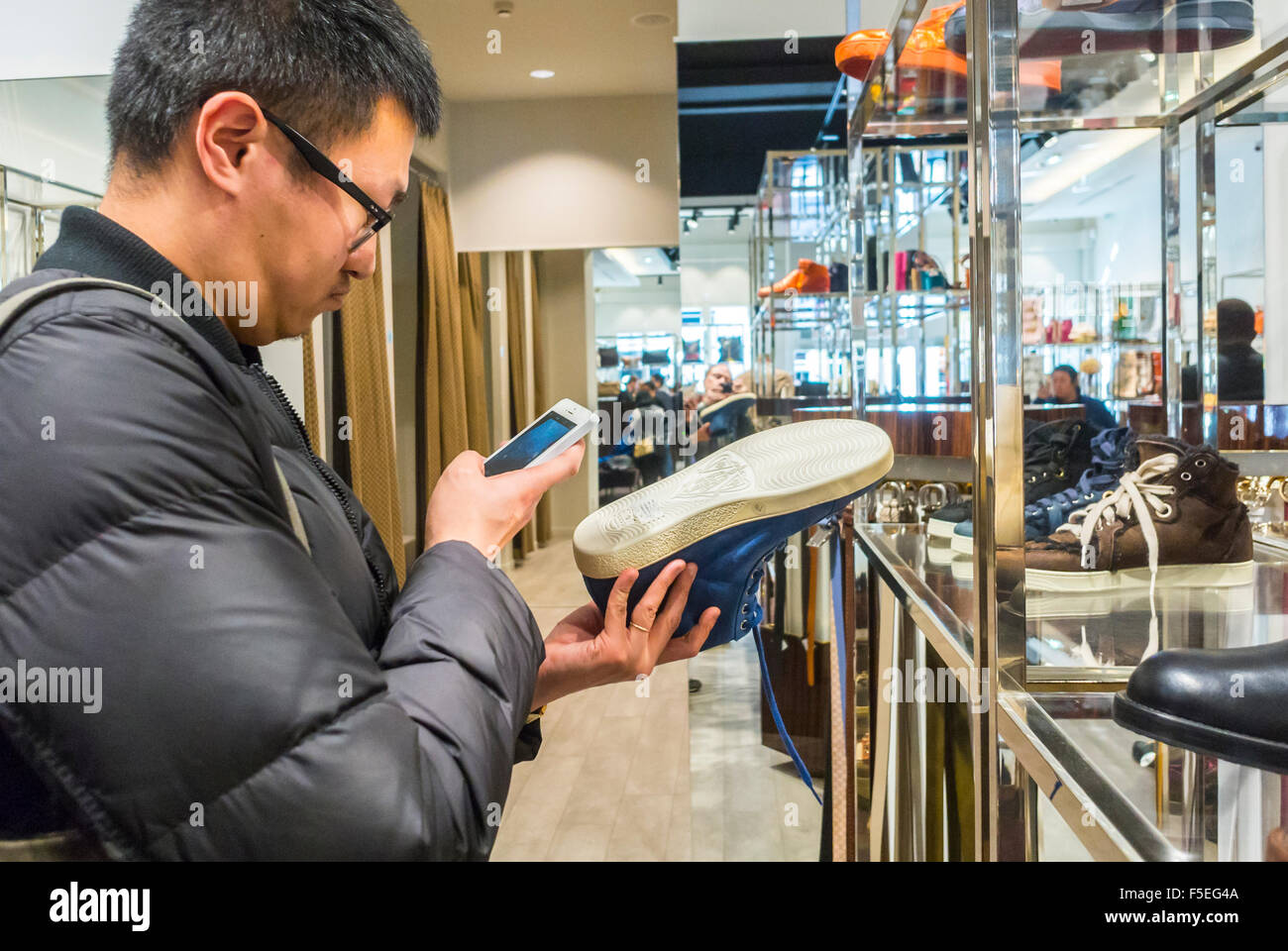 Paris, France, Europe Chinese Tourist Taking pictures with Iphone while  Shopping shoes in Luxury Stores in "La Vallee Village", Discount Shops,  Gucci Stock Photo - Alamy