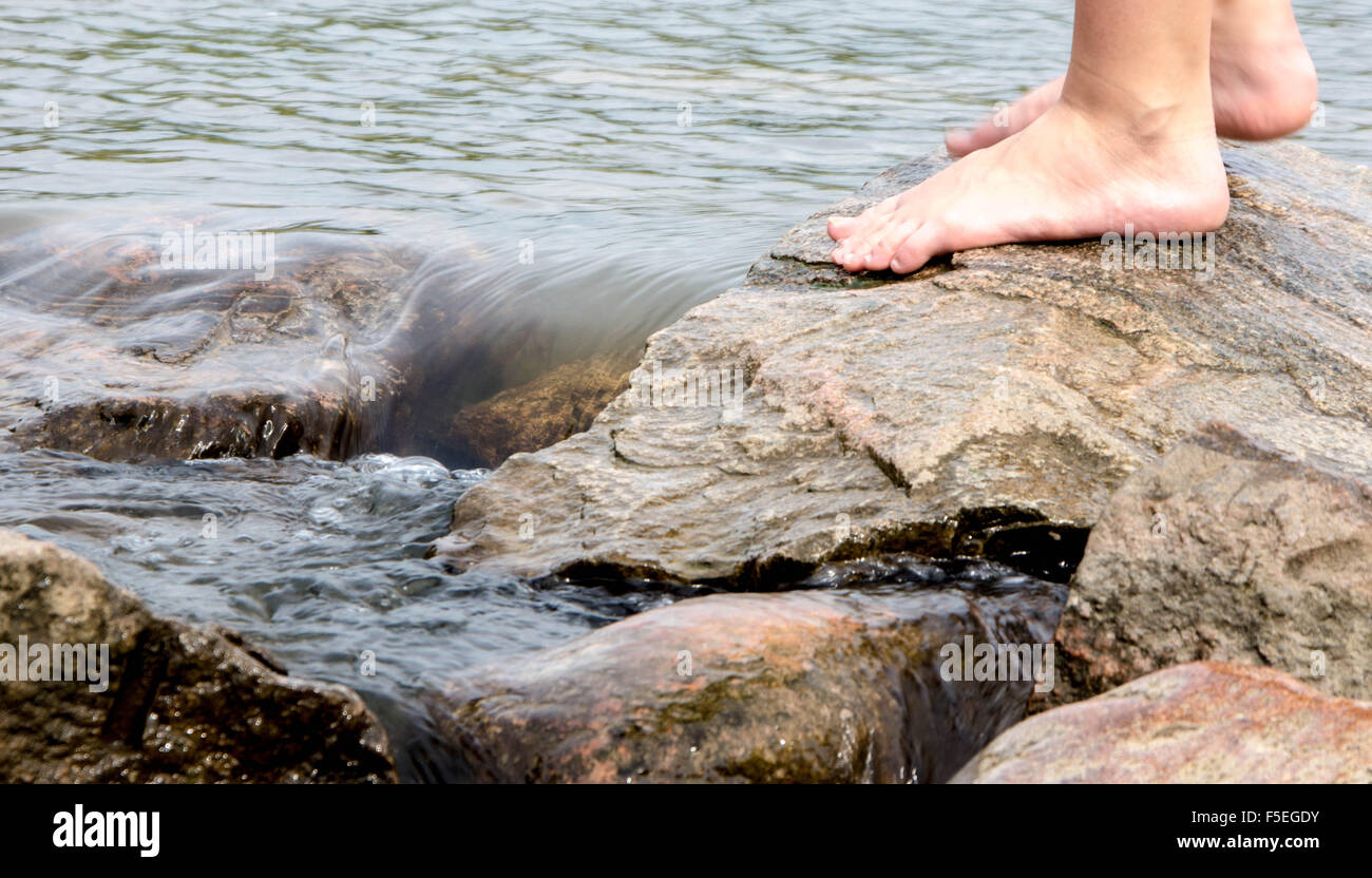 Person's feet standing on rocks at the beginning of the Mississippi ...
