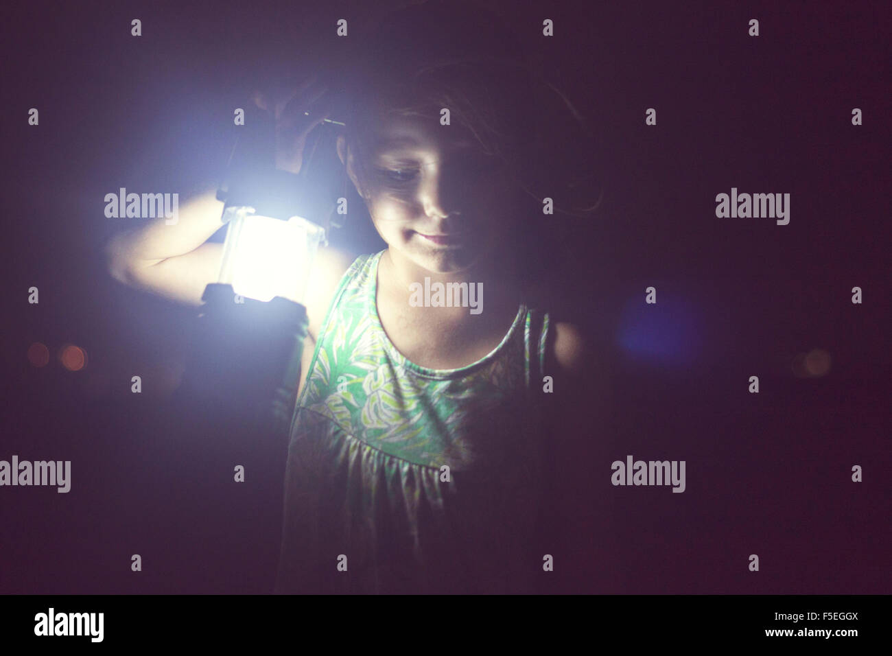 Girl holding lamp in the darkness Stock Photo