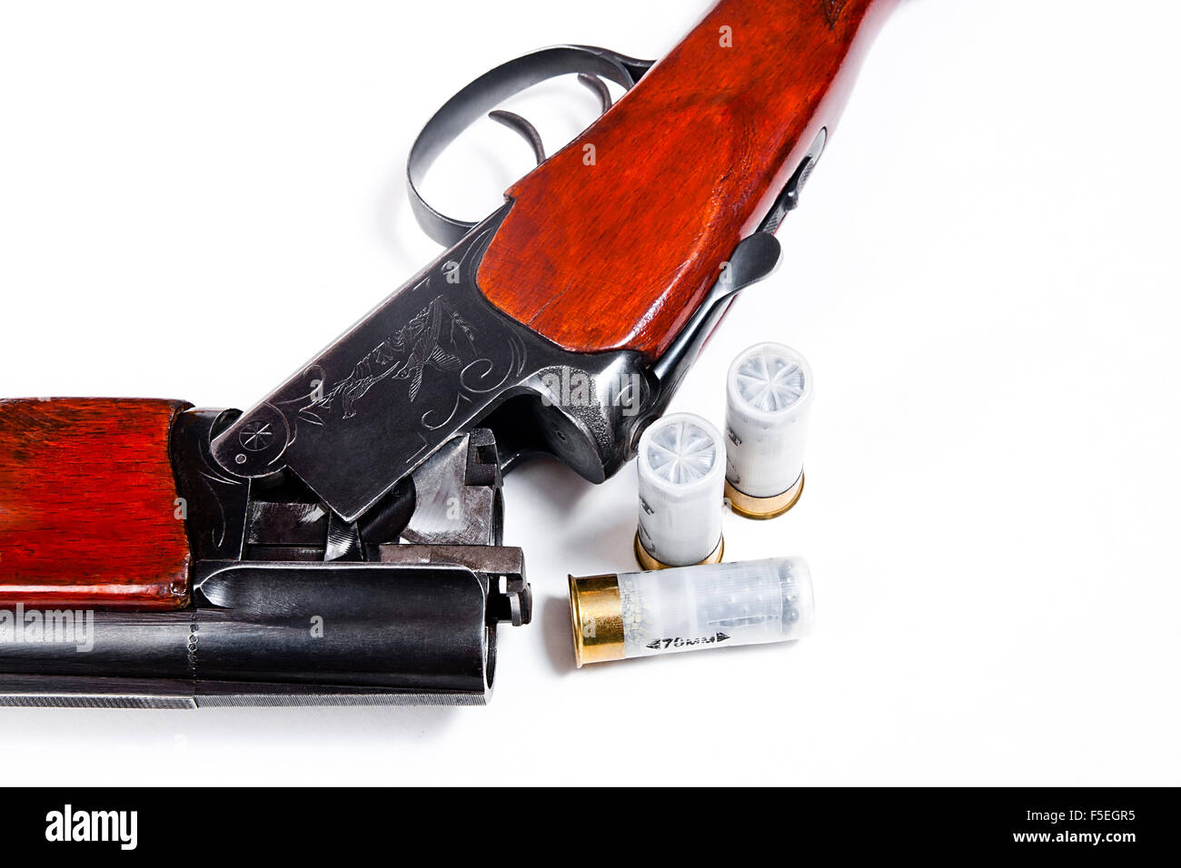 Hunting shotgun and ammunition on white background. Cartridges for hunting rifle. Close up view showing mechanism of rifle Stock Photo