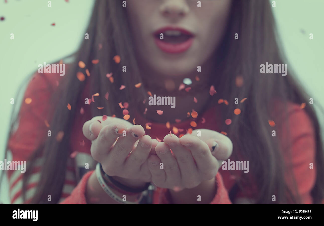 Girl blowing confetti Stock Photo Alamy