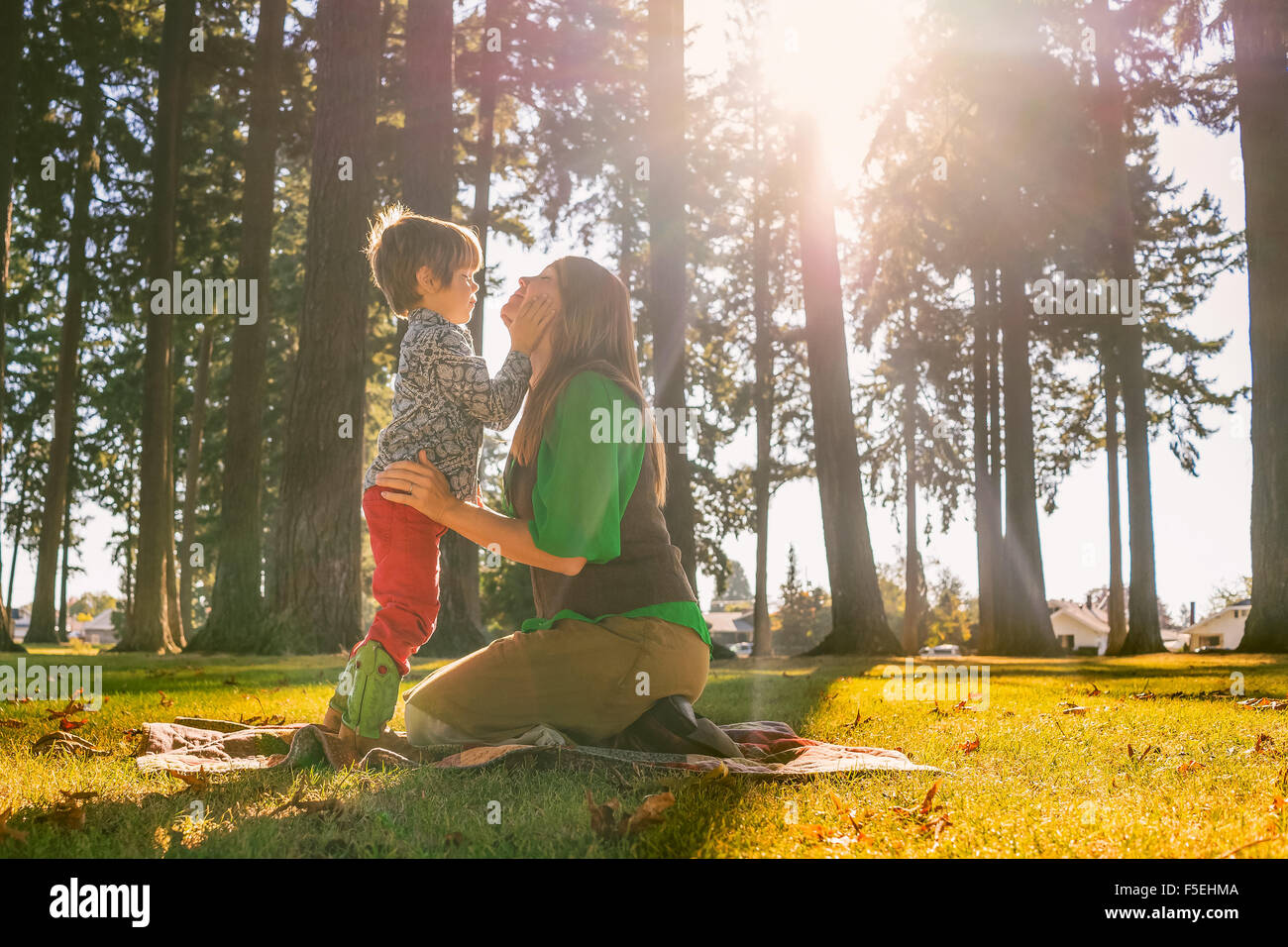 Mother and son touching with smiling faces Stock Photo