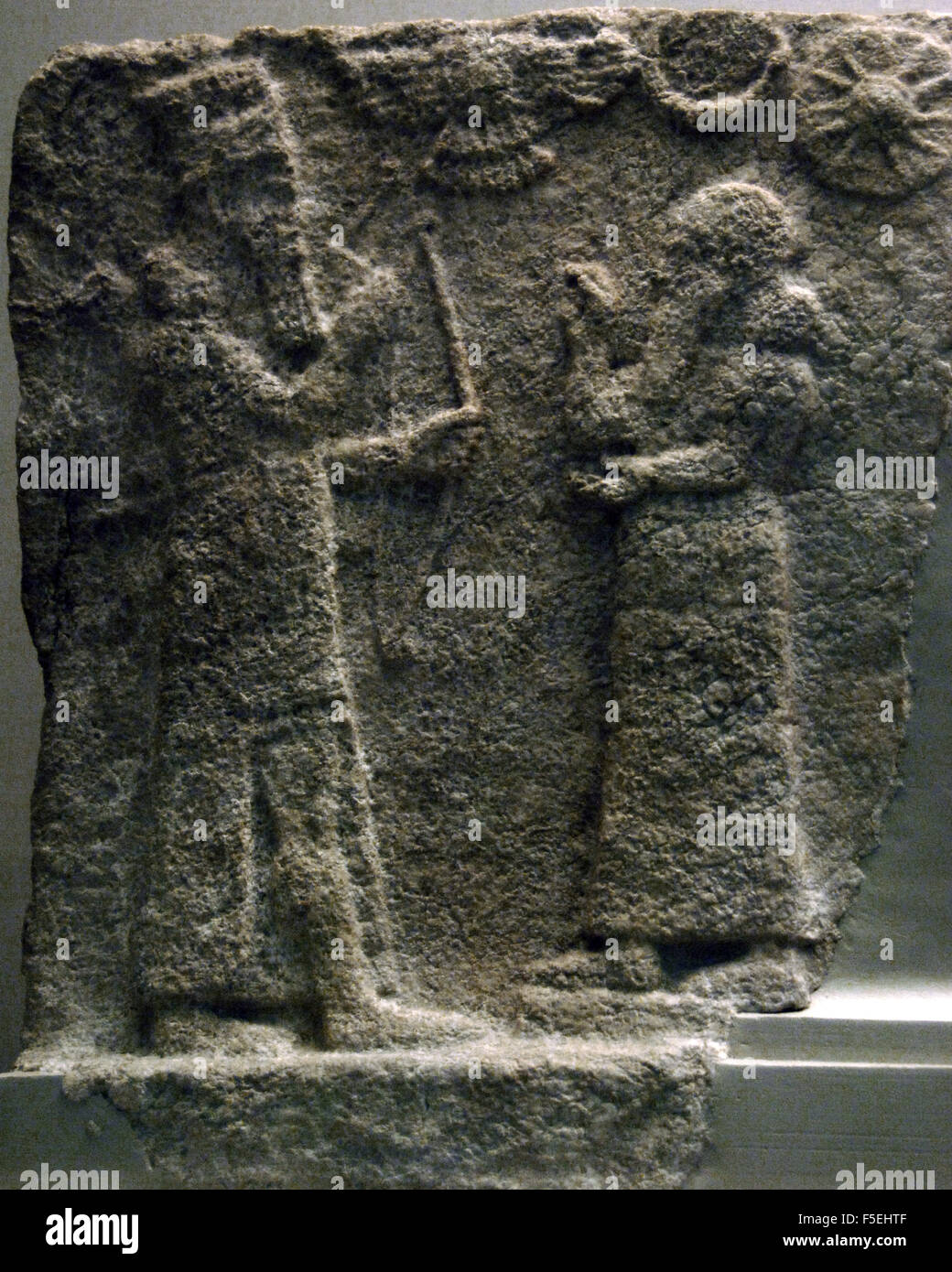 Neo-Assyrian Art. Gypsum tile from a domestic shrine depicting a man in Assyrian court dress that is worshipping a god, perhaps Ninurta. The symbols at the top represent Shamash the sun god, Sin the moon god, and Ishtar the goddess of the planet Venus. Dated 800-700 B.C. British Museum. London. United Kingdom. Stock Photo