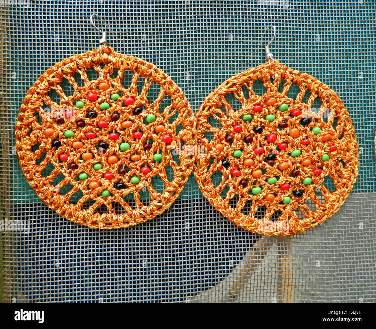 Beautiful pair of hand made ornaments for the ears of wool and plastic. Stock Photo