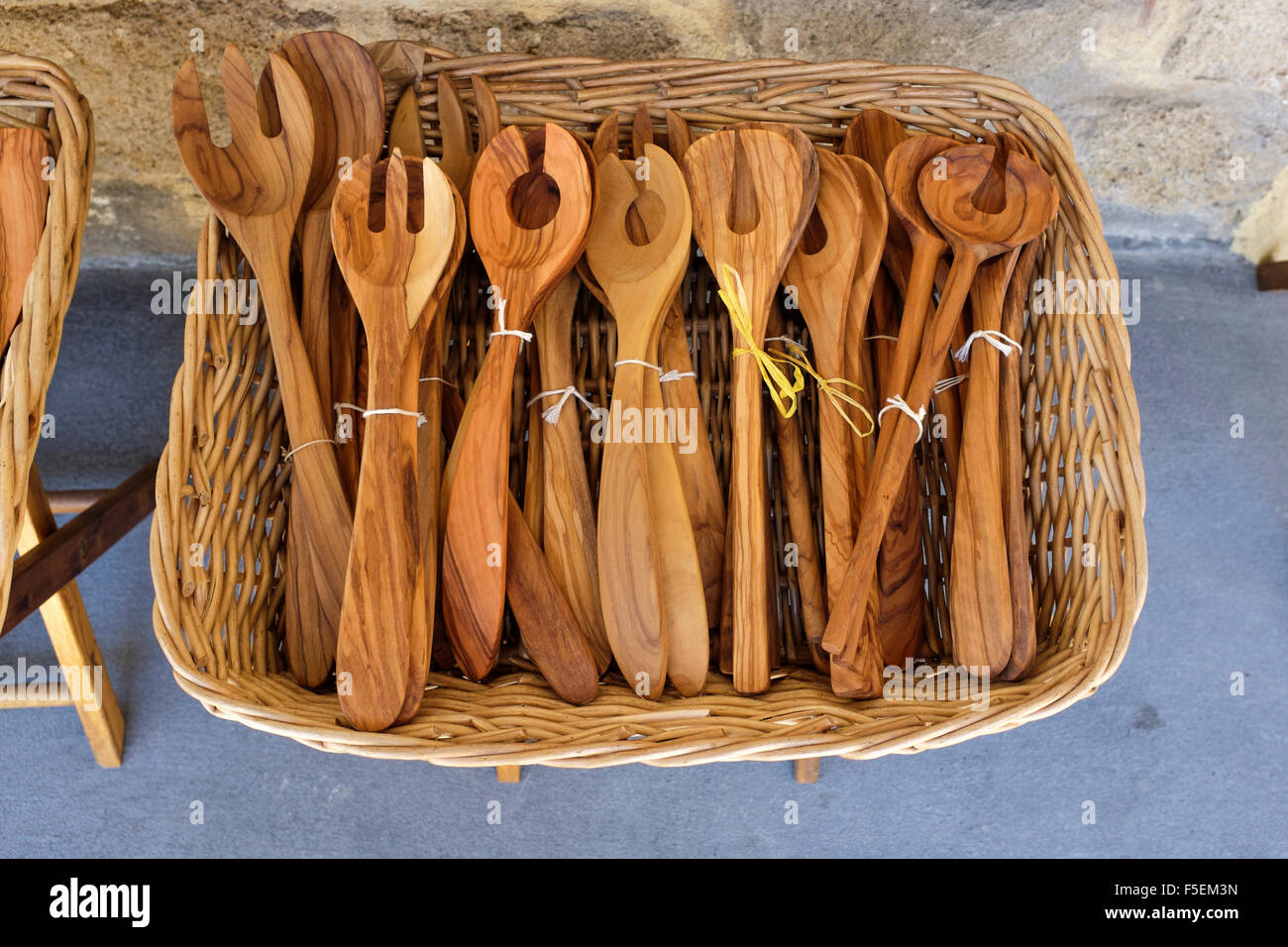 A display of olive wood items for sale outside a gift shop in the old