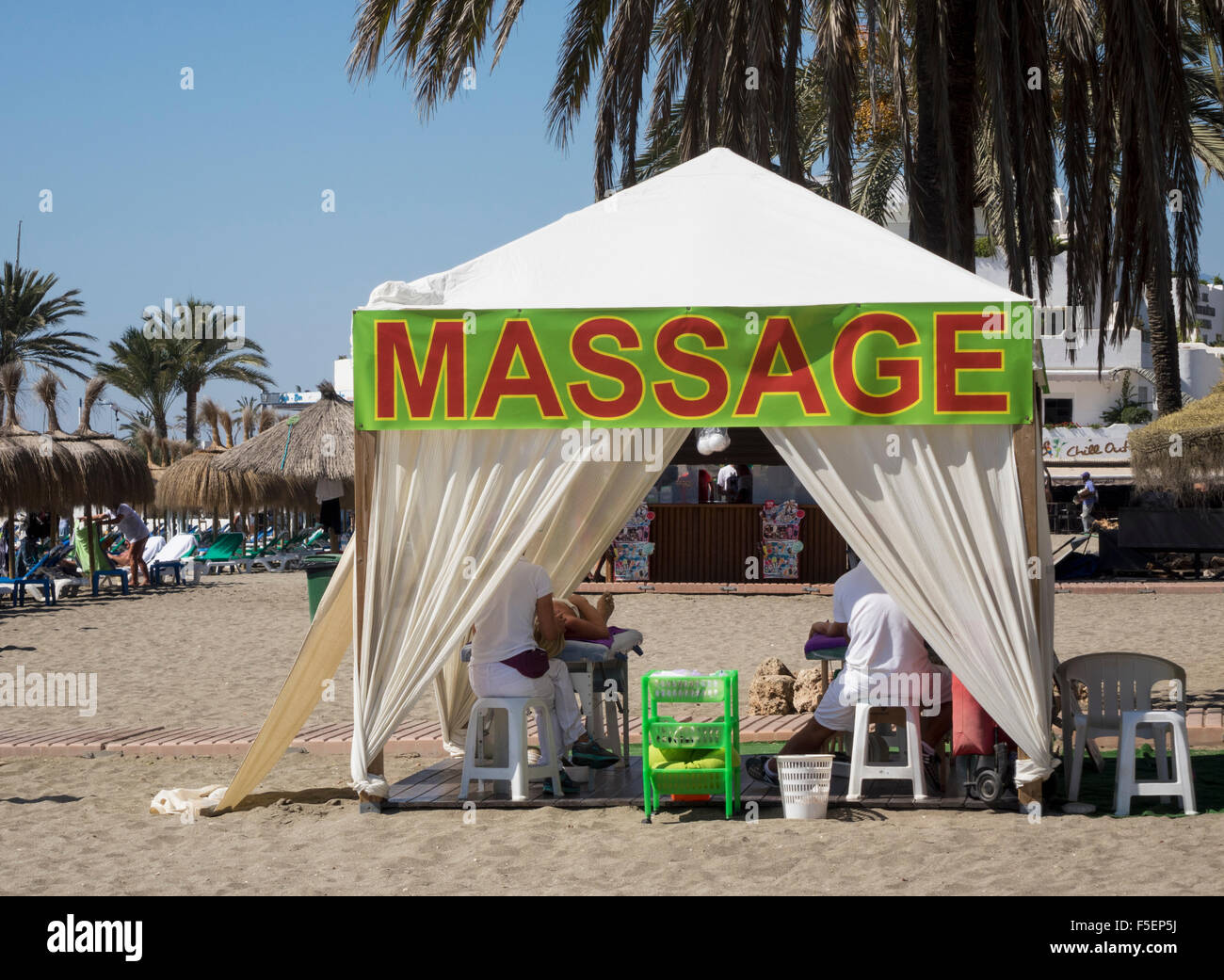 Massage tent with clients on the beach in Marbella, Spain Stock Photo