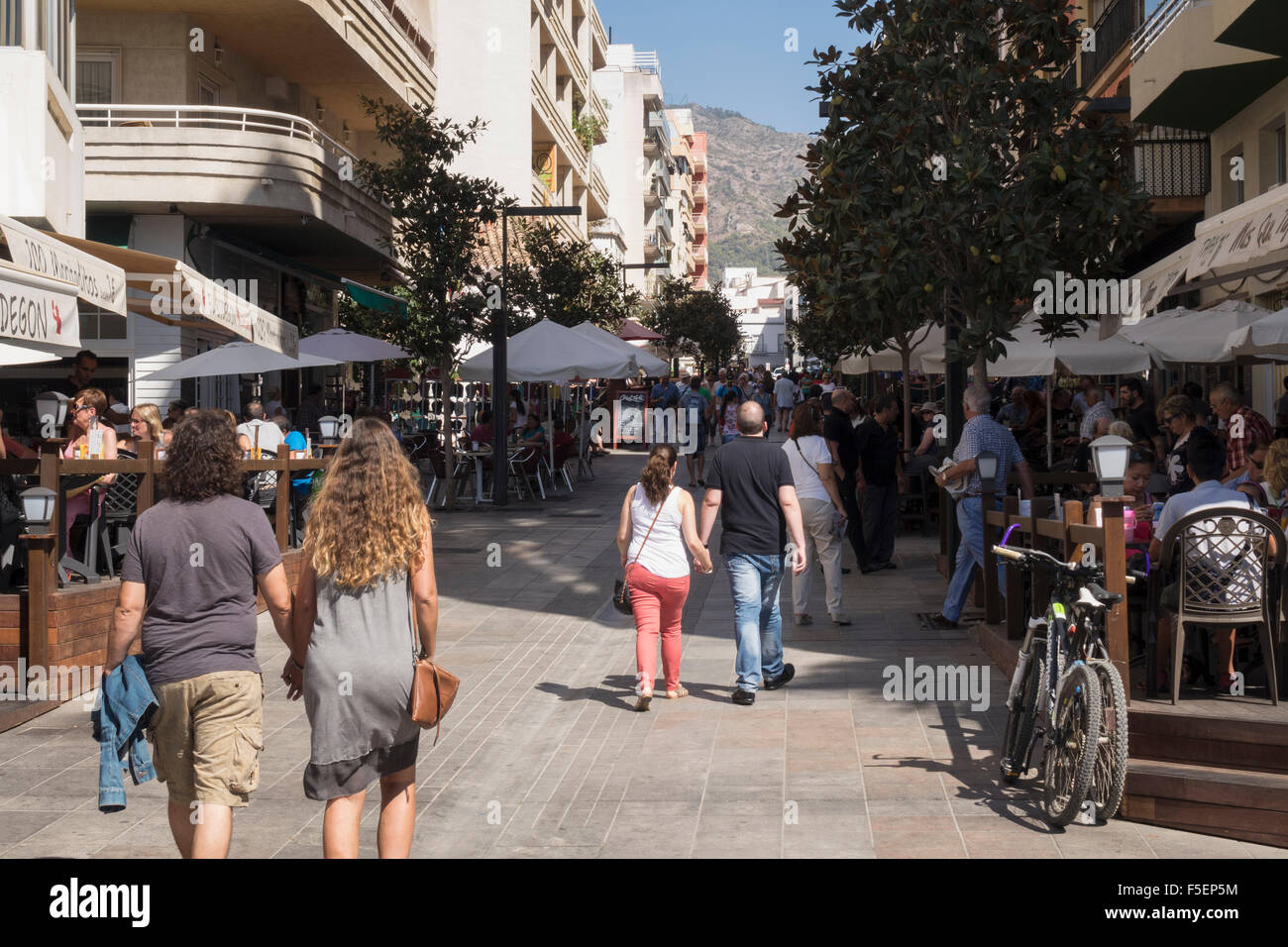 Tourists and restaurants in Avenue Miguel Cano in Marbella, Andalucia, Spain Stock Photo